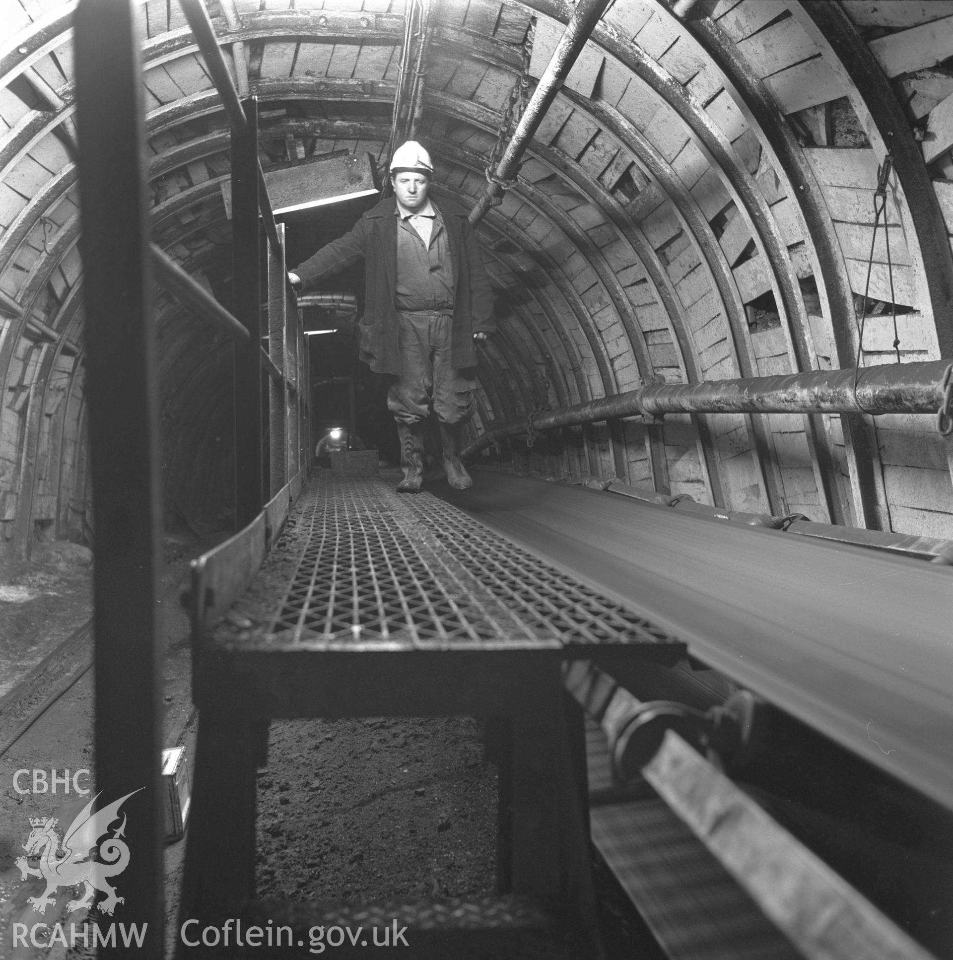 Digital copy of an acetate negative showing man riding conveyor alighting platform at New Mine, Big Pit, from the John Cornwell Collection.