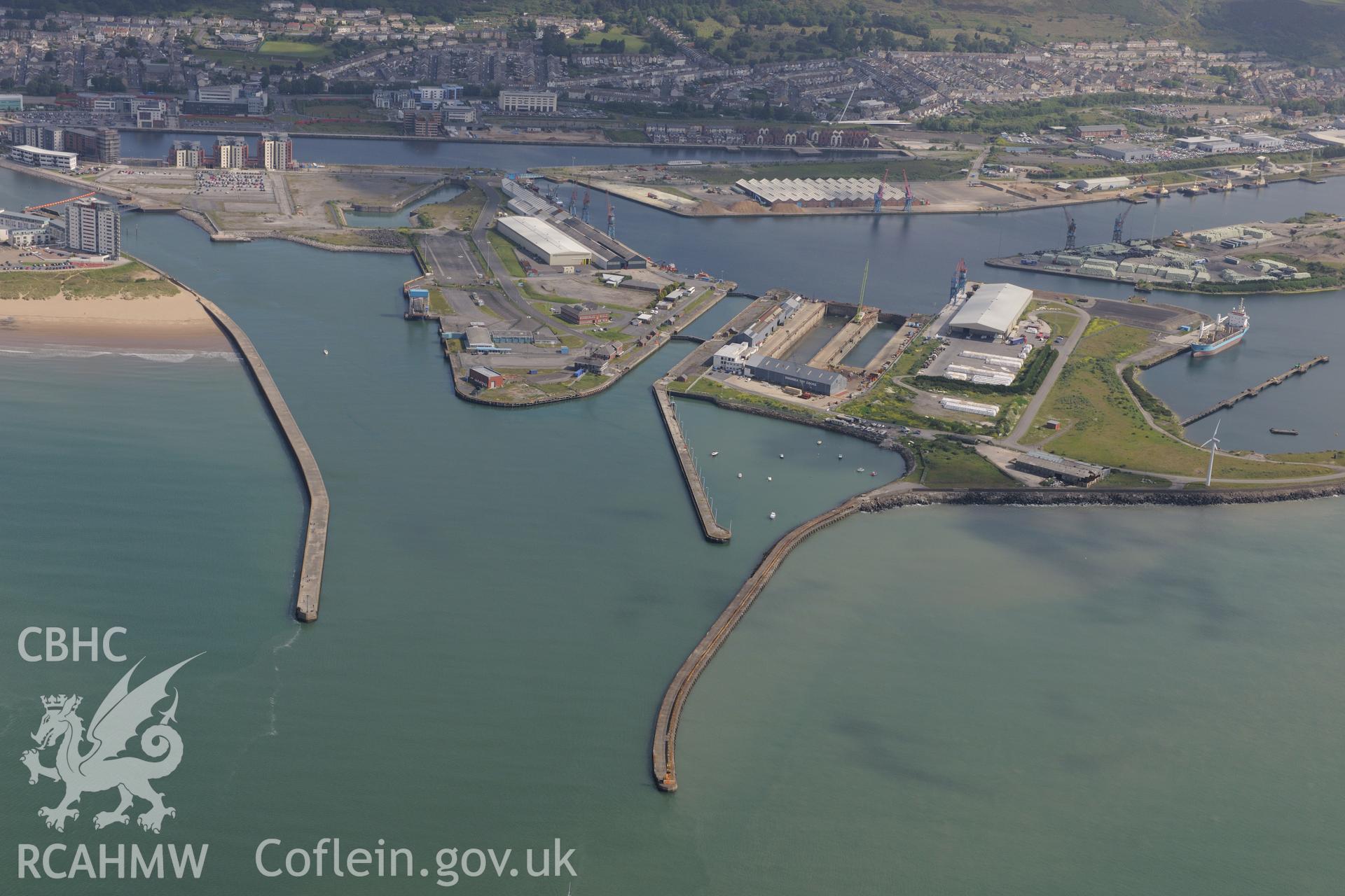 Swansea docks including the King's Dock, Queen's Dock and Prince of Wales Dock, with the city of Swansea in the distance. Oblique aerial photograph taken during the Royal Commission's programme of archaeological aerial reconnaissance by Toby Driver on 19th June 2015.