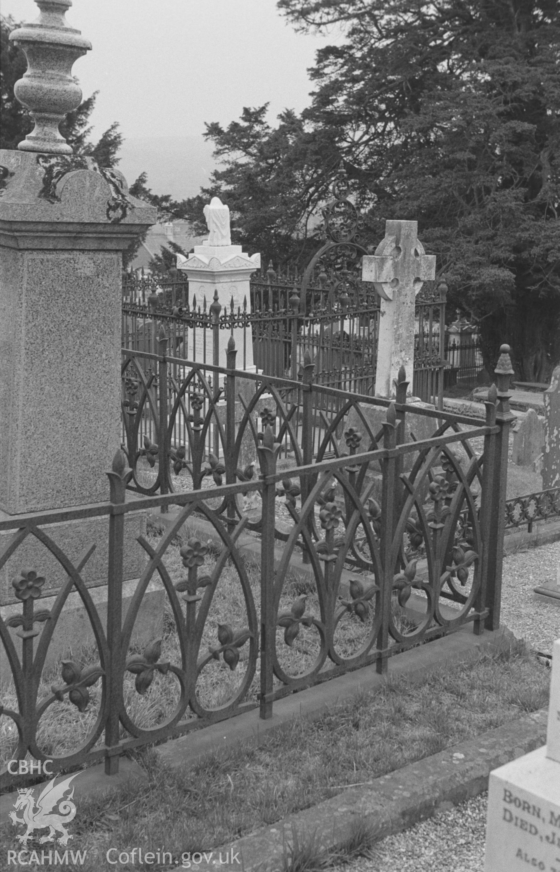 Digital copy of a black and white negative showing view of cast iron grave enclosure in the churchyard at St. Peters church, Lampeter. Photographed in March 1964 by Arthur O. Chater from Grid Reference SN 575 483, looking south east.