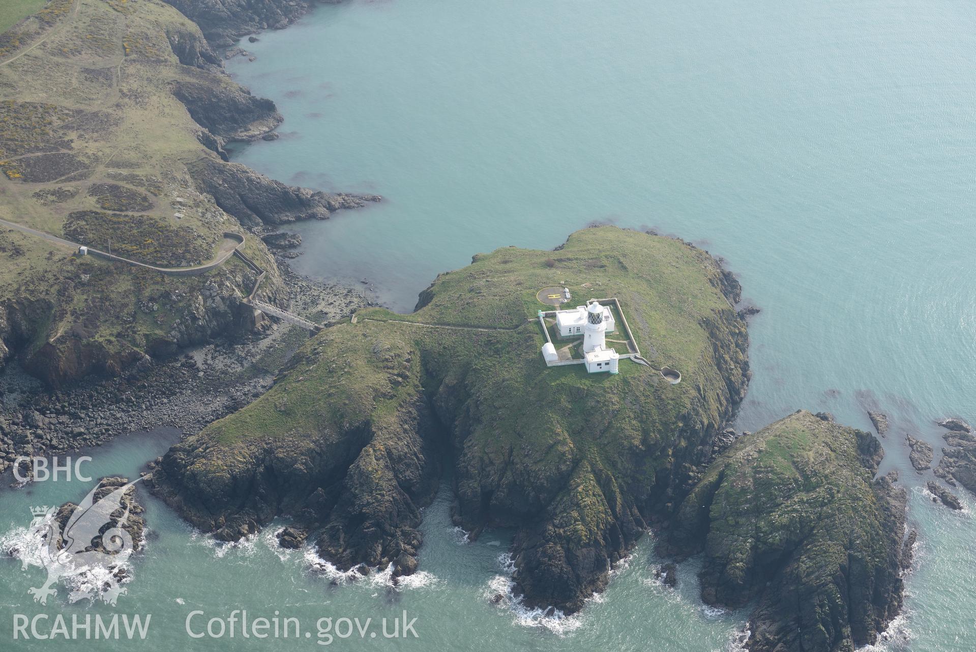 Aerial photography of Strumble Head lighthouse taken on 27th March 2017. Baseline aerial reconnaissance survey for the CHERISH Project. ? Crown: CHERISH PROJECT 2017. Produced with EU funds through the Ireland Wales Co-operation Programme 2014-2020. All material made freely available through the Open Government Licence.