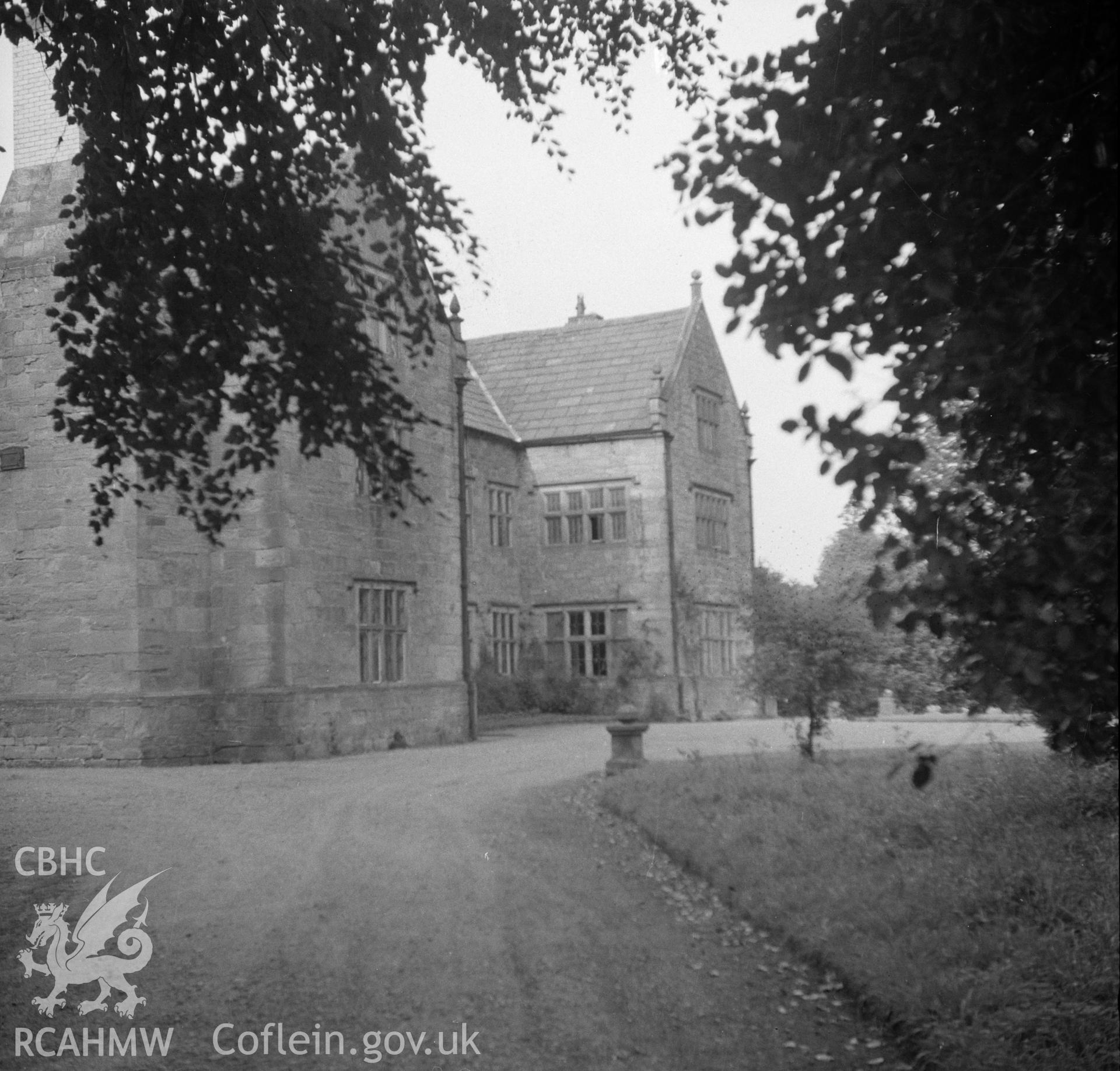 Digital copy of a black and white nitrate negative showing exterior, oblique view of front elevation, Pentrehobyn Hall.