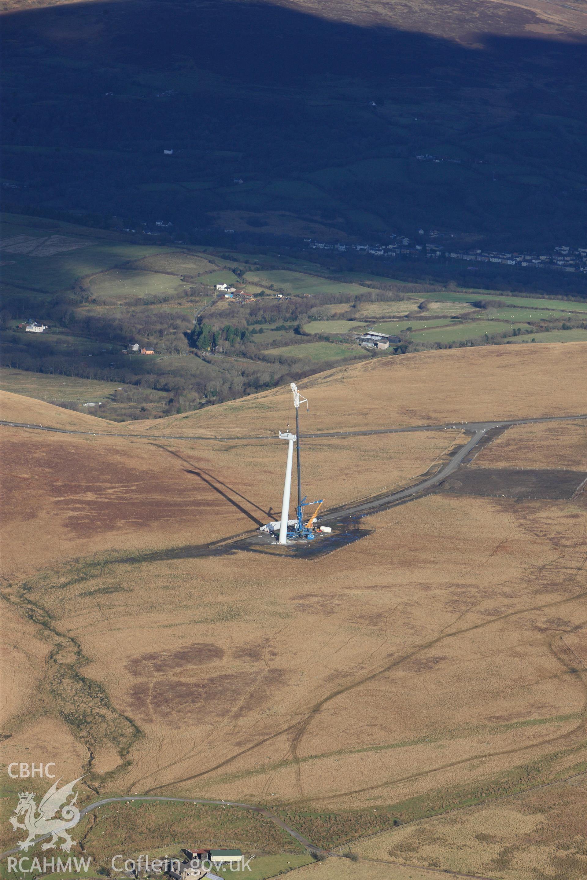 RCAHMW colour oblique photograph of Mynydd y Betws windfarm, view of turbine (at NGR) under installation, from south. Taken by Toby Driver on 28/11/2012.
