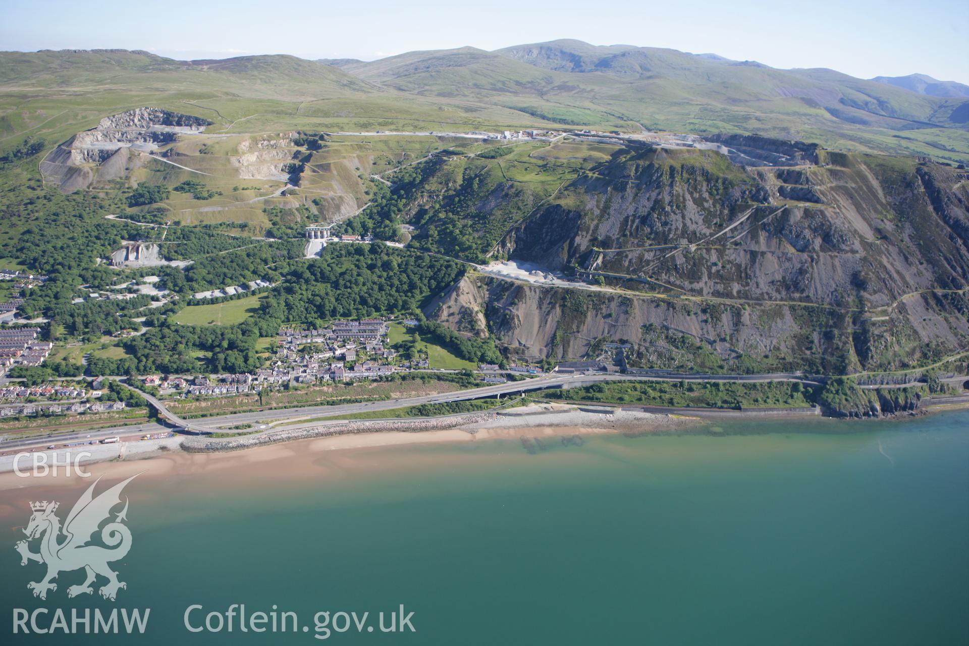 RCAHMW colour oblique photograph of Penmaenmawr Stone Quarry, with Penmaermawr town below. Taken by Toby Driver on 16/06/2010.