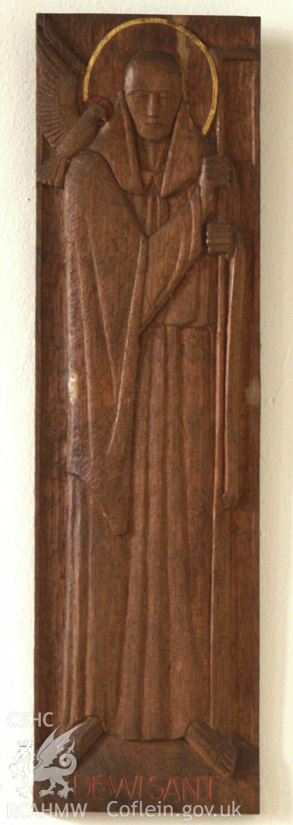 Digital colour photograph showing carved oak relief by Eric Gill depicting St David at St Mary and St Michael Catholic church, Llanarth.