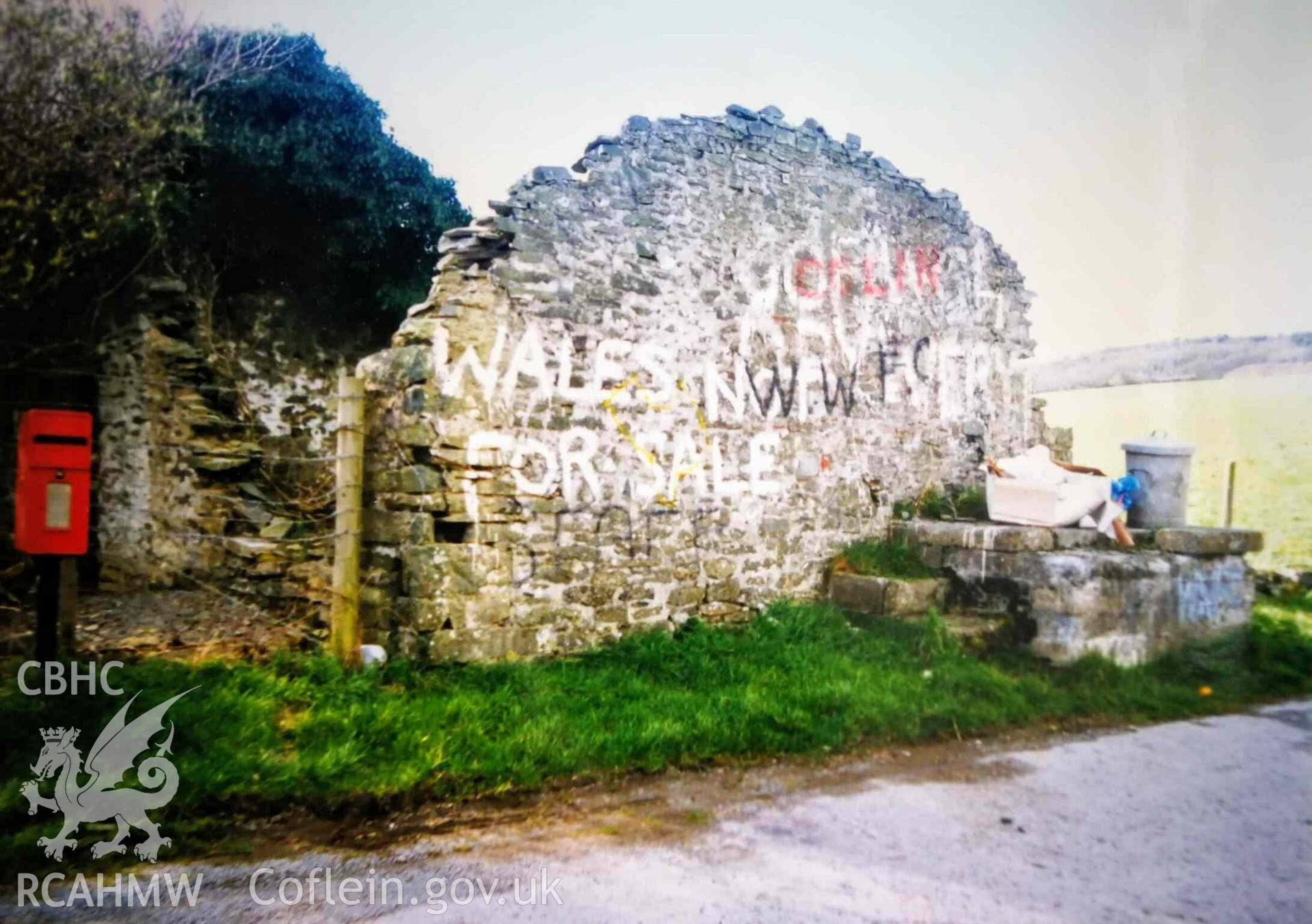 Photograph of graffiti on ruined gable wall of a cottage known as Troed-y-rhiw, taken in c. 1988.
