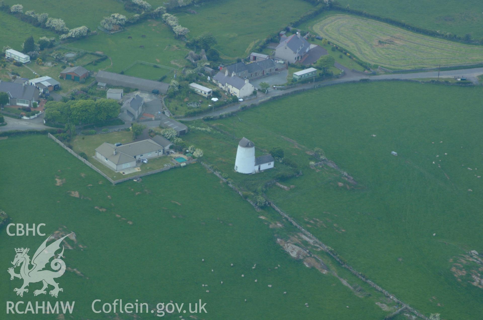 RCAHMW colour oblique aerial photograph of Disused Windmill, Mynydd Mechell. Taken on 26 May 2004 by Toby Driver