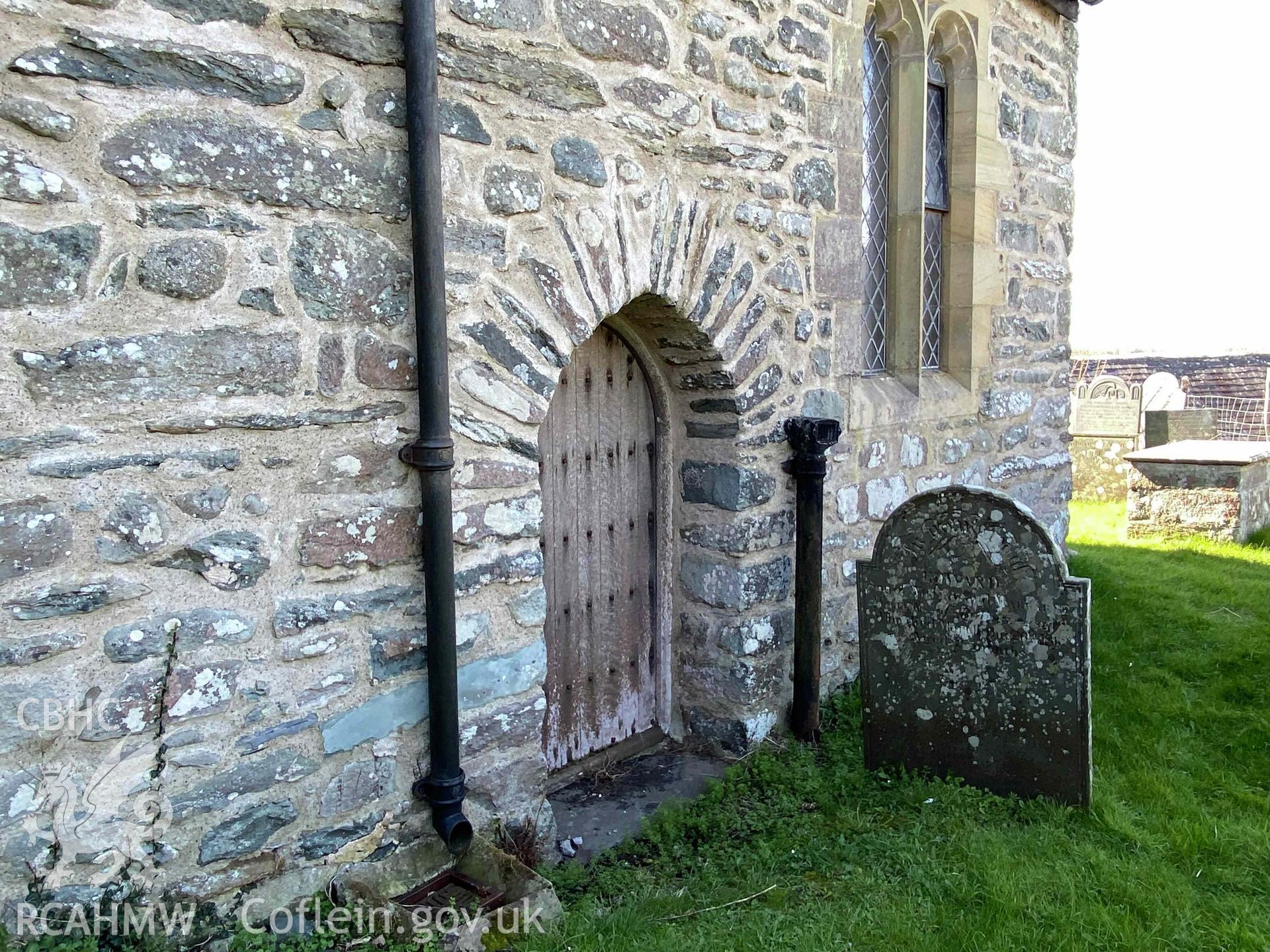 Digital photograph showing exterior view of door at St Dwywe's Church, Llanddwywe-Is-y-Craig, produced by Paul Davis in 2023