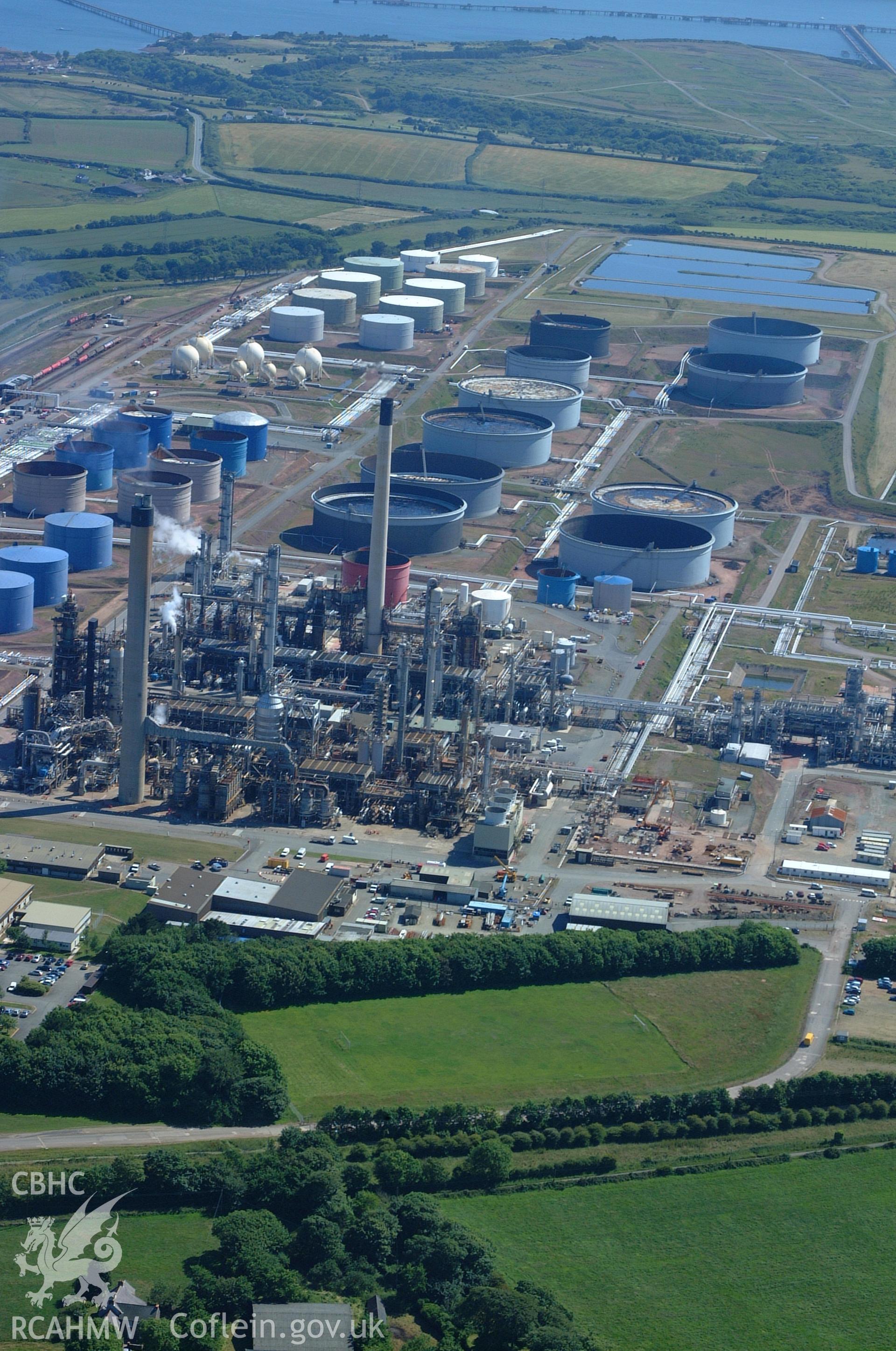 RCAHMW colour oblique aerial photograph of Amoco Oil Refinery, Milford Haven taken on 15/06/2004 by Toby Driver