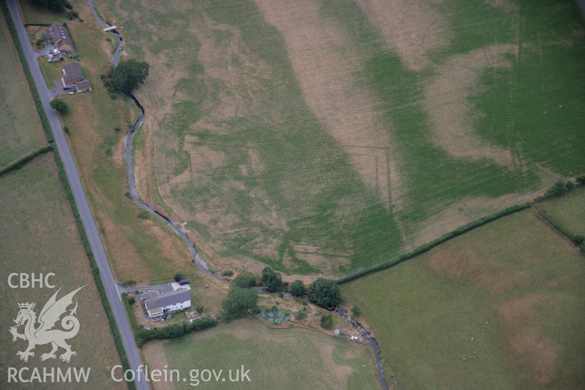 RCAHMW colour oblique aerial photograph of Nant Magwr Roman site, cropmarks from the north-east, by Toby Driver, 27/07/2006.