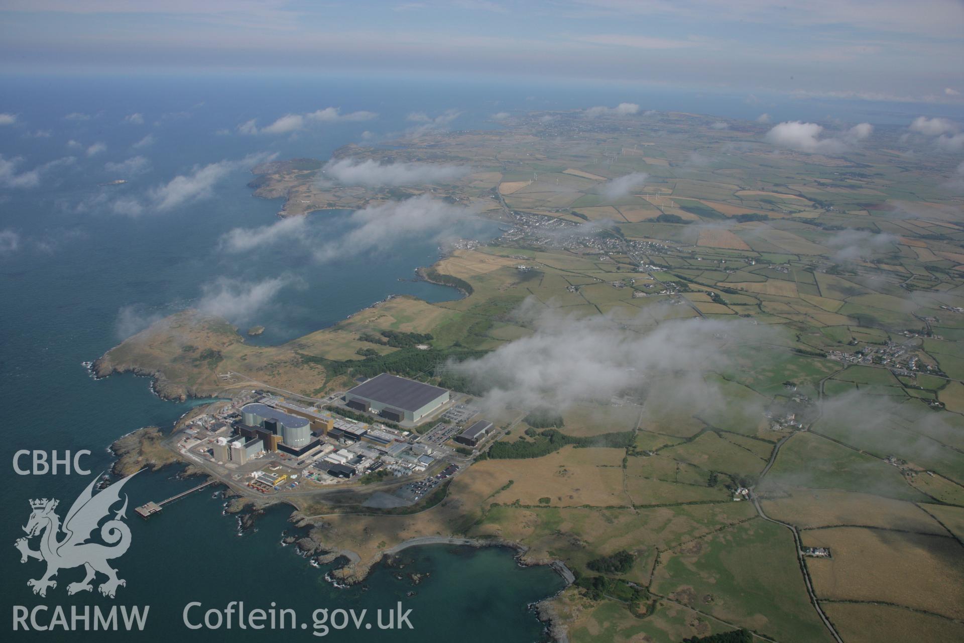 RCAHMW colour oblique aerial photograph of Wylfa Nuclear Power Station. A high landscape view. Taken on 14 August 2006 by Toby Driver.