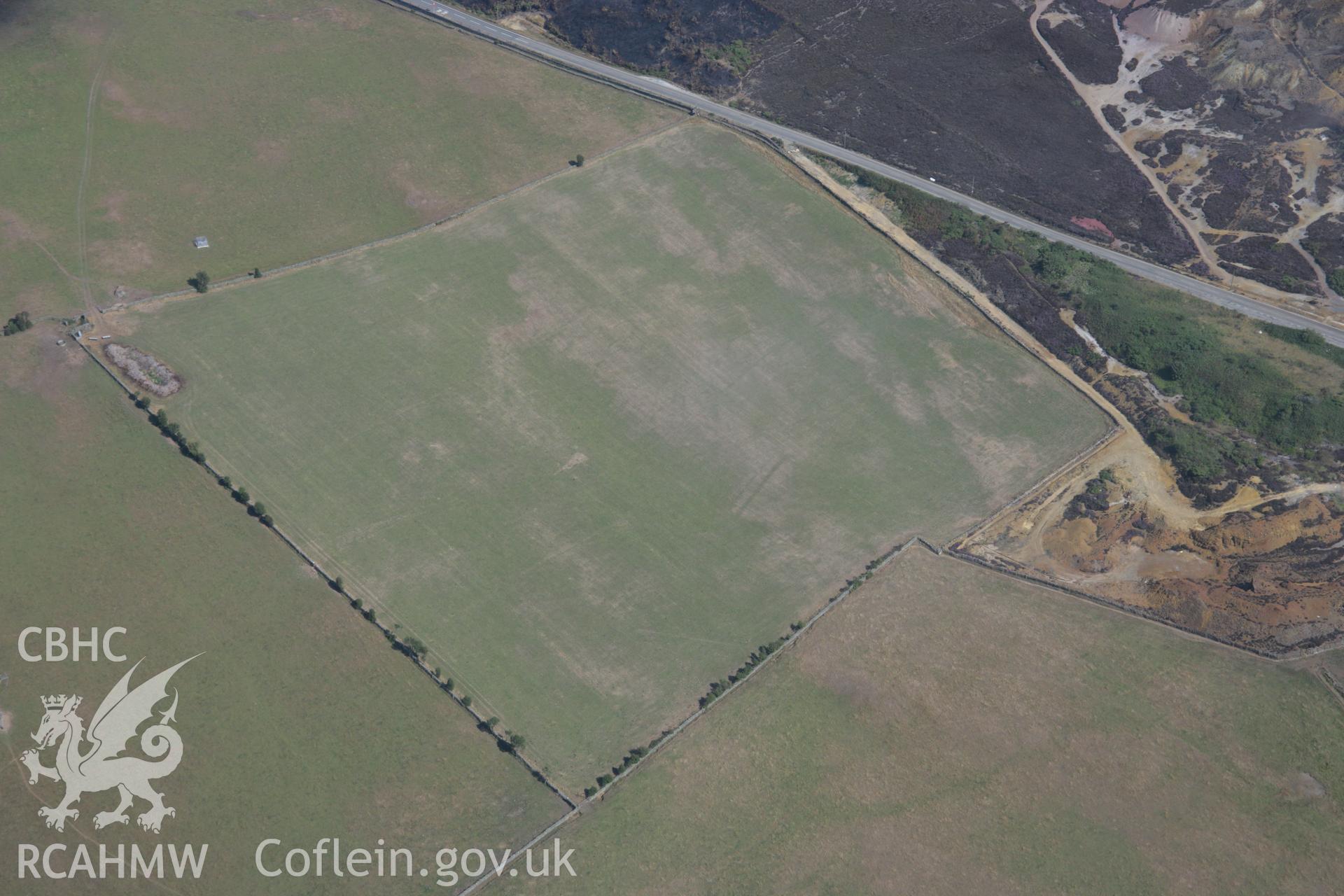 RCAHMW colour oblique aerial photograph showing non-archaeological cropmarks to the north of Parys Mountain Copper Mines, Amlwch. Taken on 14 August 2006 by Toby Driver.