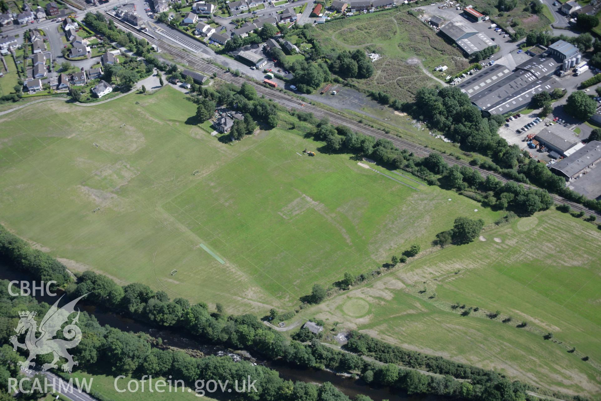 RCAHMW colour oblique aerial photograph of Llandovery from the north-west, with non-archaeological parchmarks on playing fields showing former river channels and pitches Taken on 02 September 2005 by Toby Driver