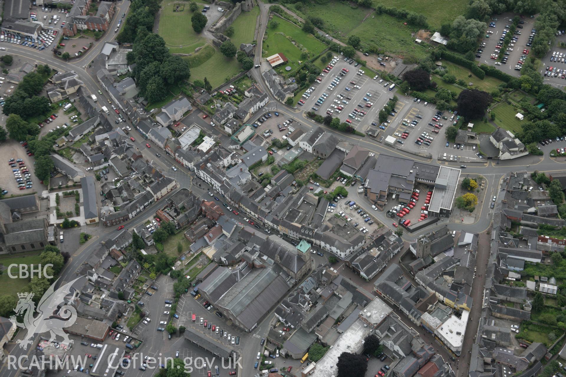 RCAHMW colour oblique aerial photograph of Abergavenny from the north with the town hall and market buildings. Taken on 07 July 2005 by Toby Driver