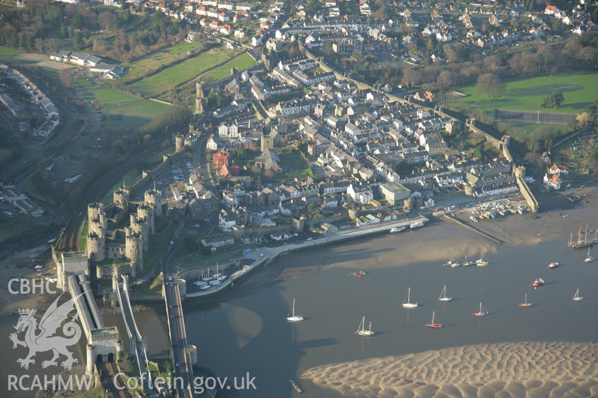RCAHMW colour oblique aerial photograph of Conwy Castle and the town walls. Plas Mawr is also visible. Taken on 25 January 2007 by Toby Driver
