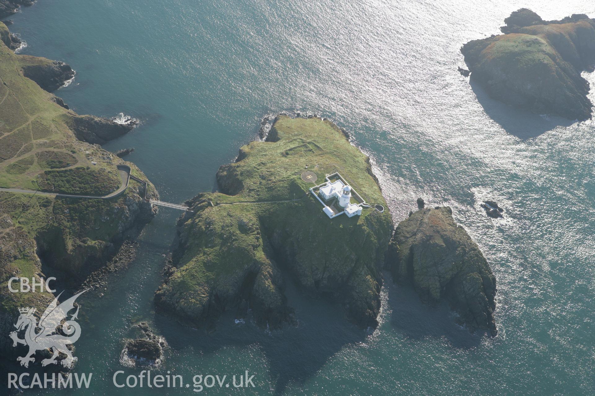 RCAHMW colour oblique photograph of Strumble Head lighthouse;Ynys Meicel, remains of buildings. Taken by Toby Driver on 23/10/2007.