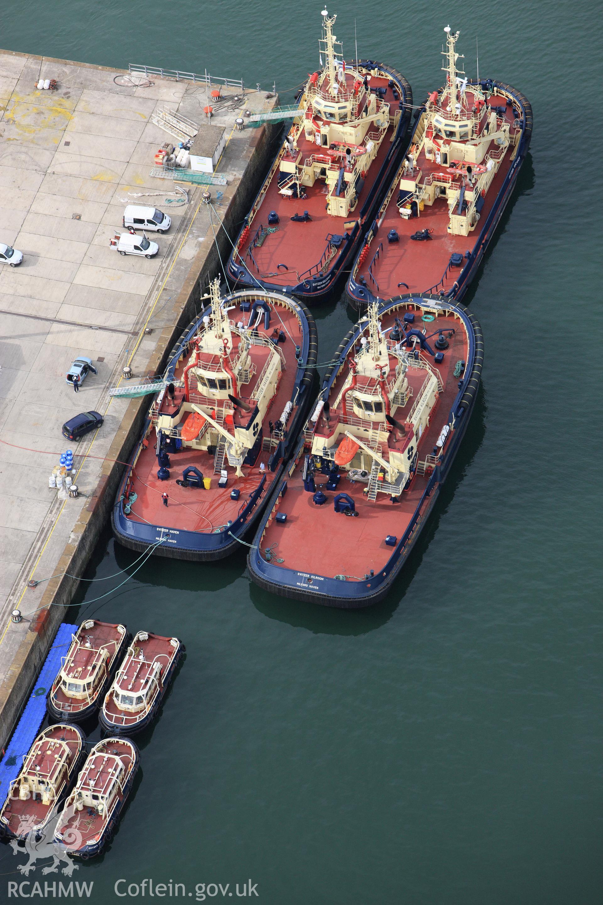 RCAHMW colour oblique aerial photograph of The Royal Dockyard at Pembroke Dock showing Port Authority tugs. Taken on 14 October 2009 by Toby Driver