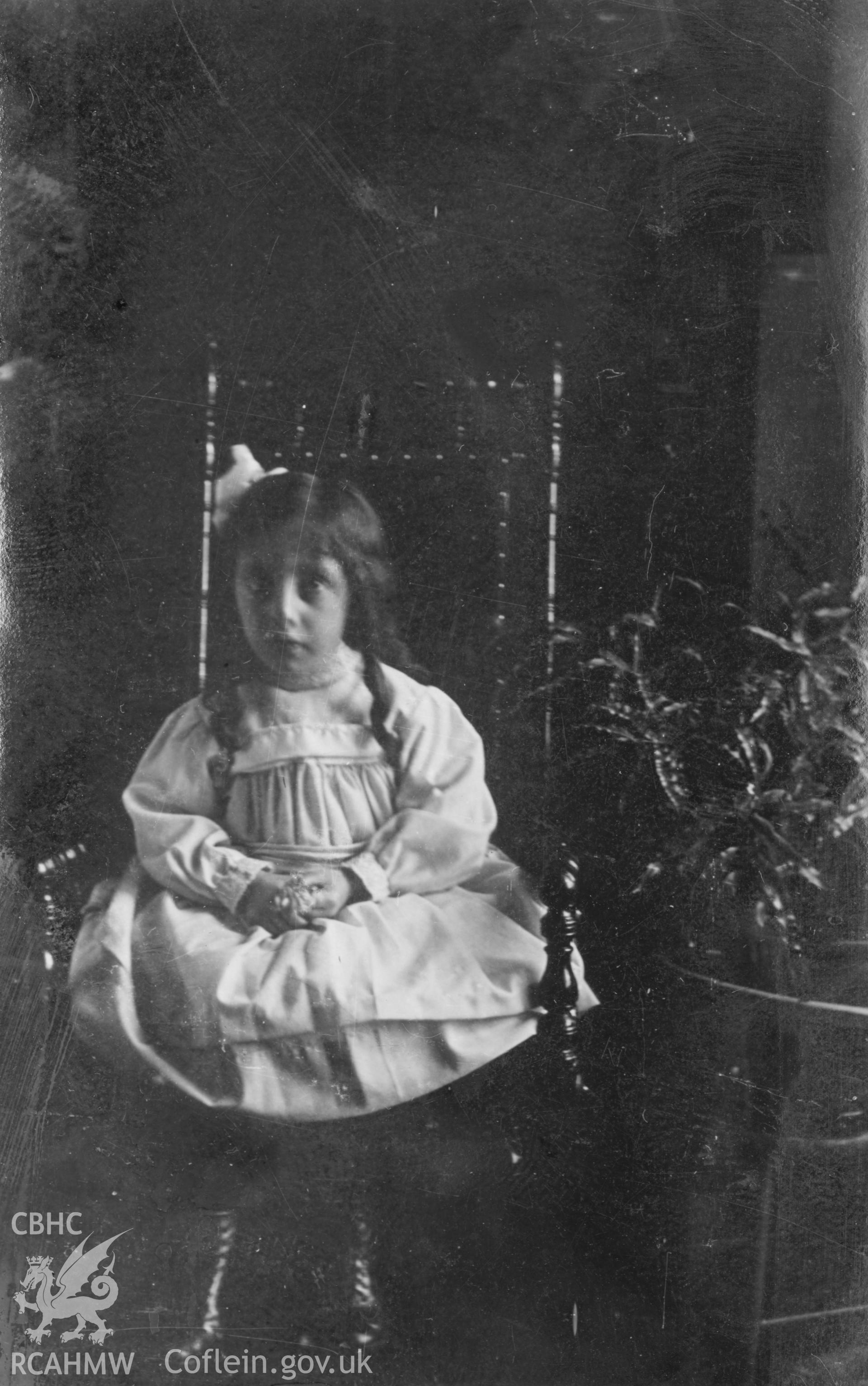 Photo of a seated female child. Digitised from a photograph album showing views of Aberystwyth and District, produced by David John Saer, school teacher of Aberystwyth. Loaned for copying by Dr Alan Chamberlain.