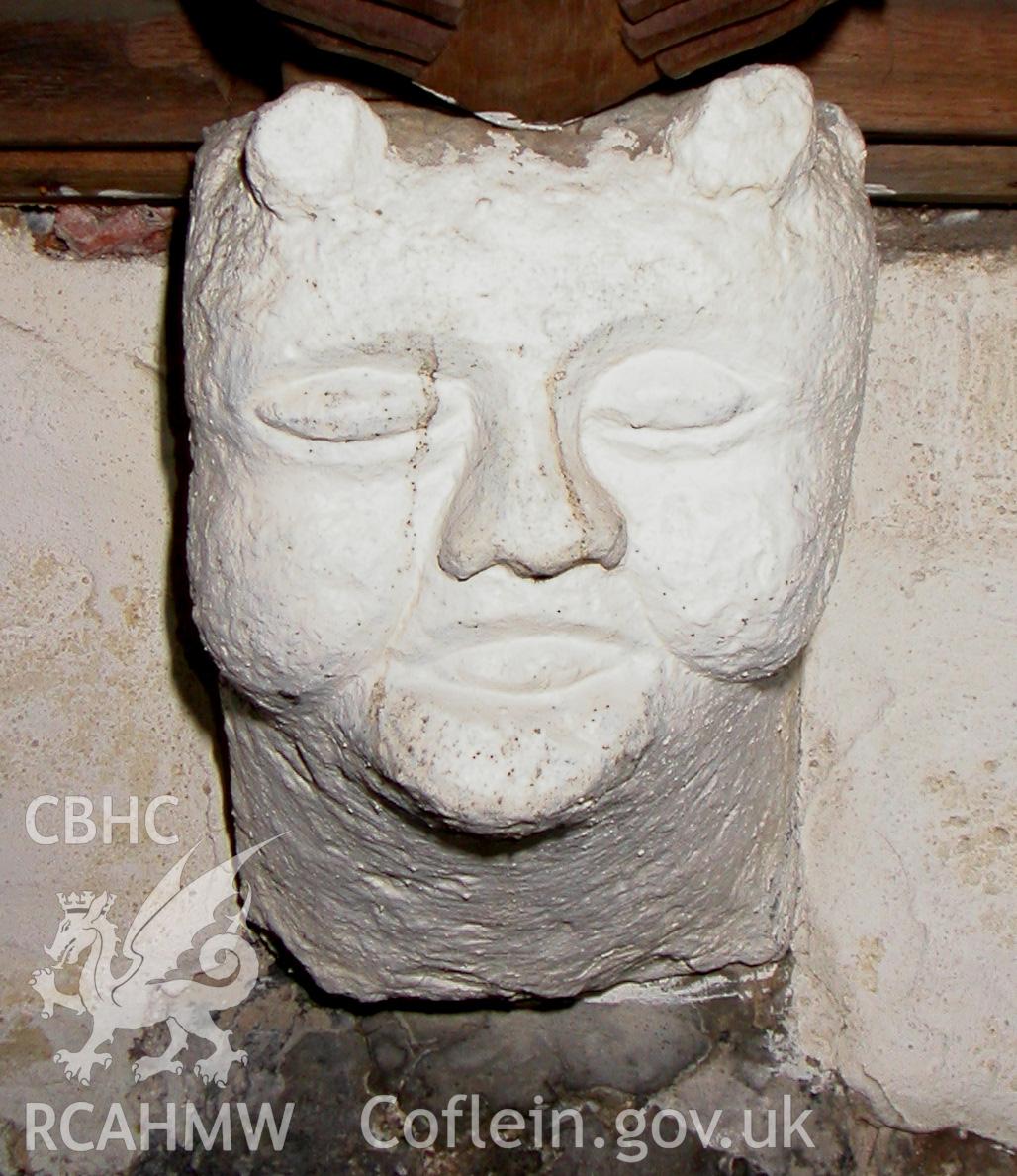 Carved stone head between Trusses VI & VII, south side.