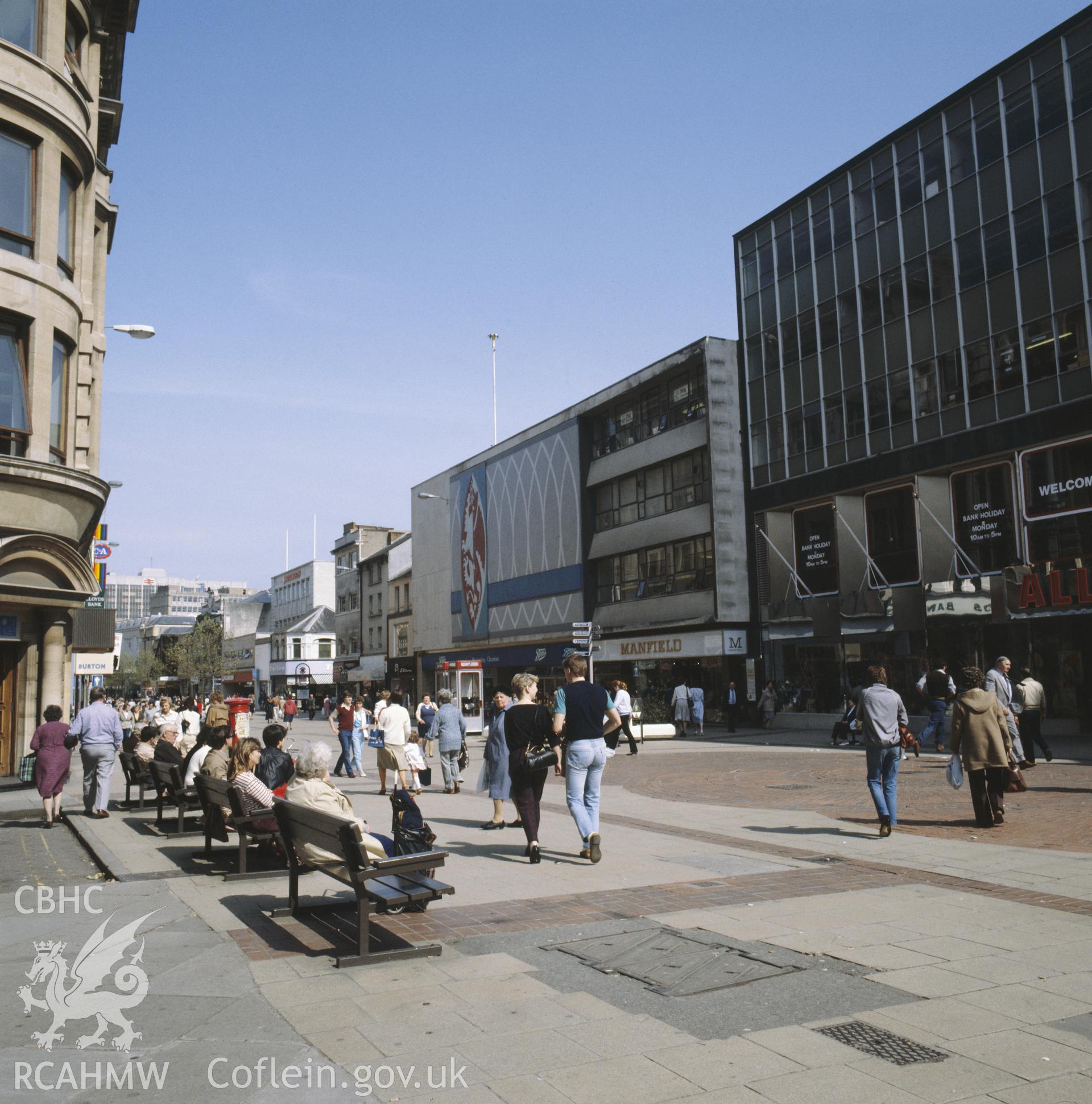 1 colour transparency showing street scene in central Cardiff with shoppers; collated by the former Central Office of Information.
