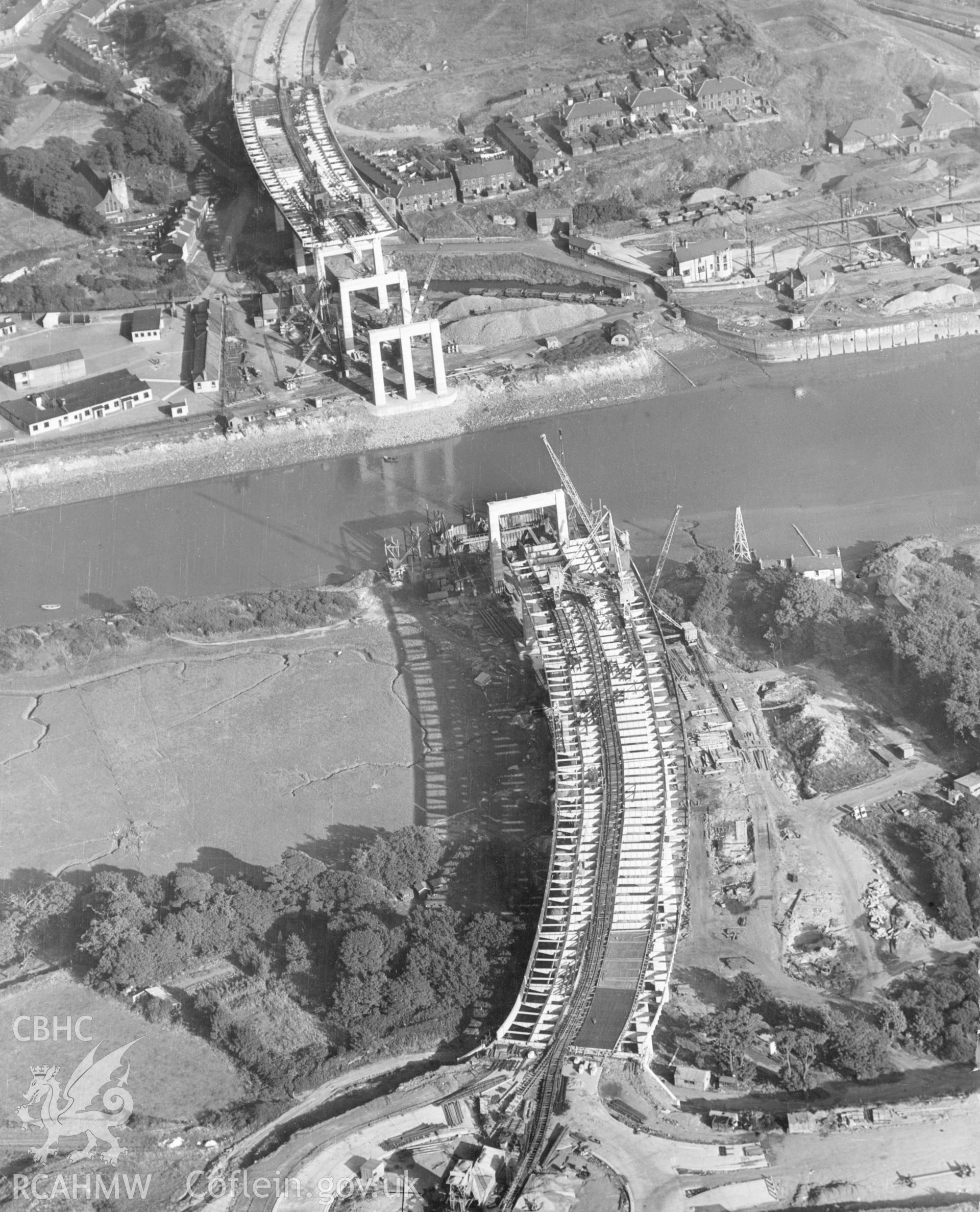 1 b/w print showing an aerial view of the A48 Neath bridge and Earleswood Roundabout under construction, dated 1952, collated by the former Central Office of Information.