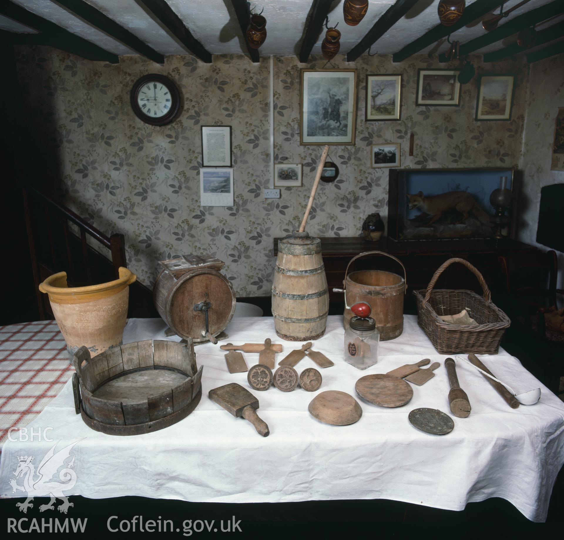 RCAHMW colour transparency showing a display of kitchen utensils on a table at Glan Ithon Farmhouse, taken by RCAHMW, undated.
