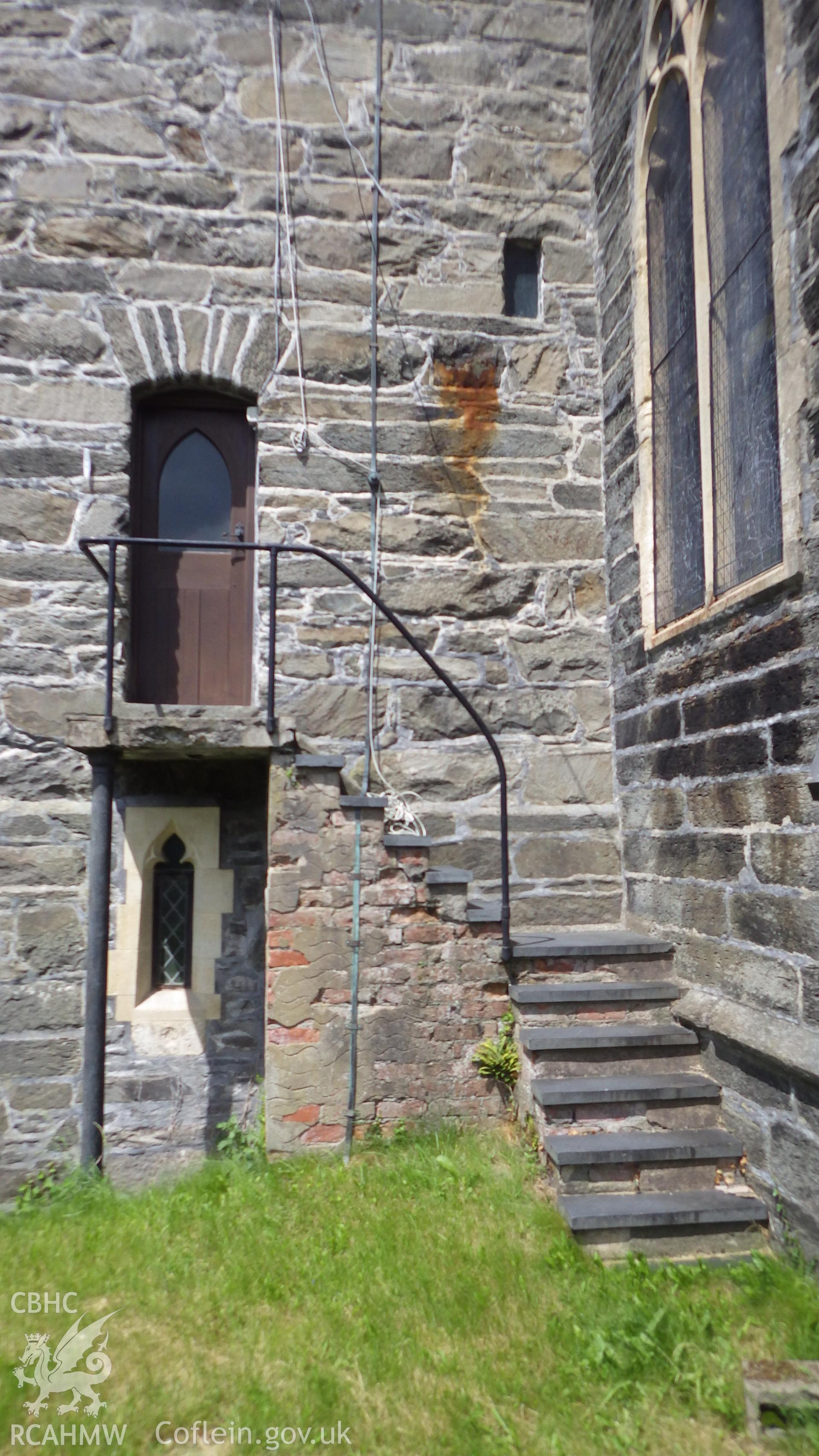 Steps to door in the tower and small window below. Stonework showing difference in periods of building between tower and main body of church