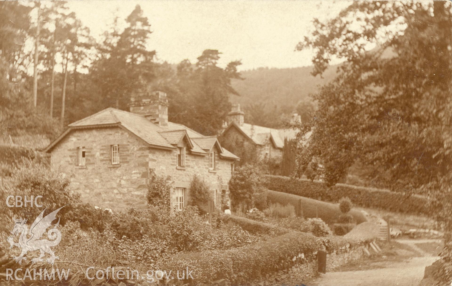 Digitised postcard image of unidentified cottages, Betws-y-coed. Produced by Parks and Gardens Data Services, from an original item in the Peter Davis Collection at Parks and Gardens UK. We hold only web-resolution images of this collection, suitable for viewing on screen and for research purposes only. We do not hold the original images, or publication quality scans.