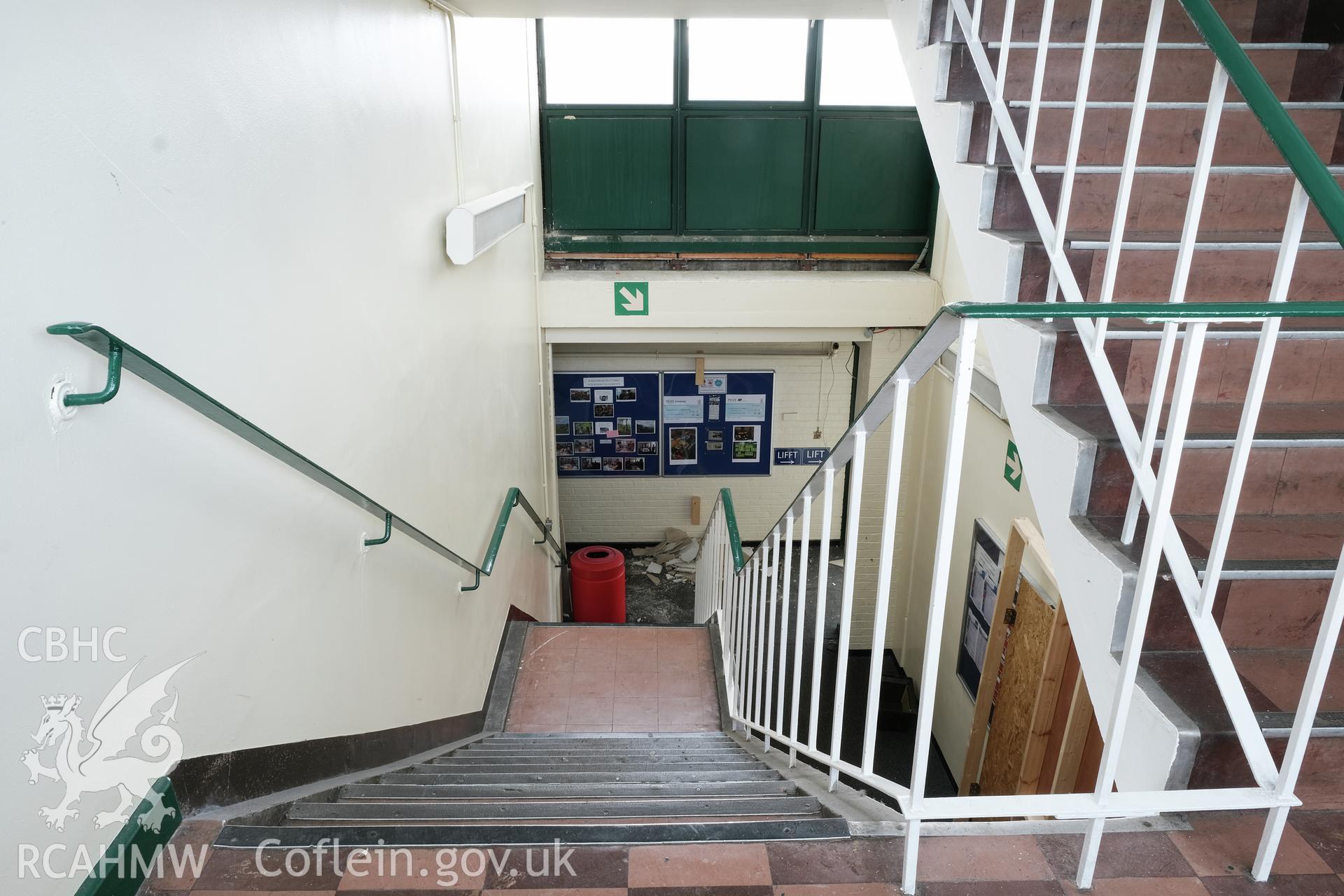 Digital colour photograph showing detailed interior view down the stairs at Caernarfonshire Technical College, Ffriddoedd Road, Bangor. Photographed by Dilys Morgan and donated by Wyn Thomas of Grwp Llandrillo-Menai Further Education College, 2019.