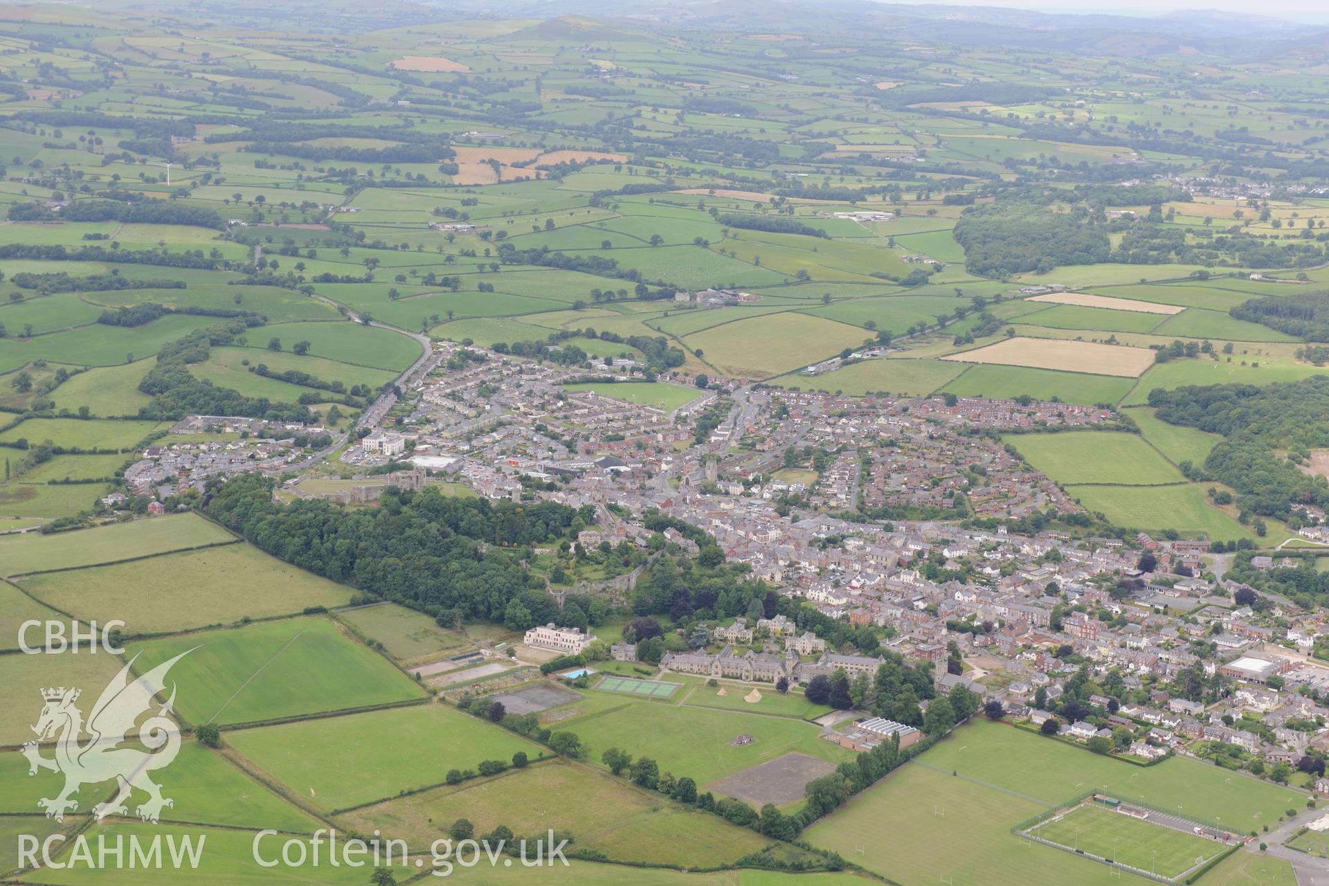 Denbigh Castle and town walls, St. David's Church, Howell's School and Coed Cwningaer, Denbigh.  Oblique aerial photograph taken during the Royal Commission's programme of archaeological aerial reconnaissance by Toby Driver on 30th July 2015.