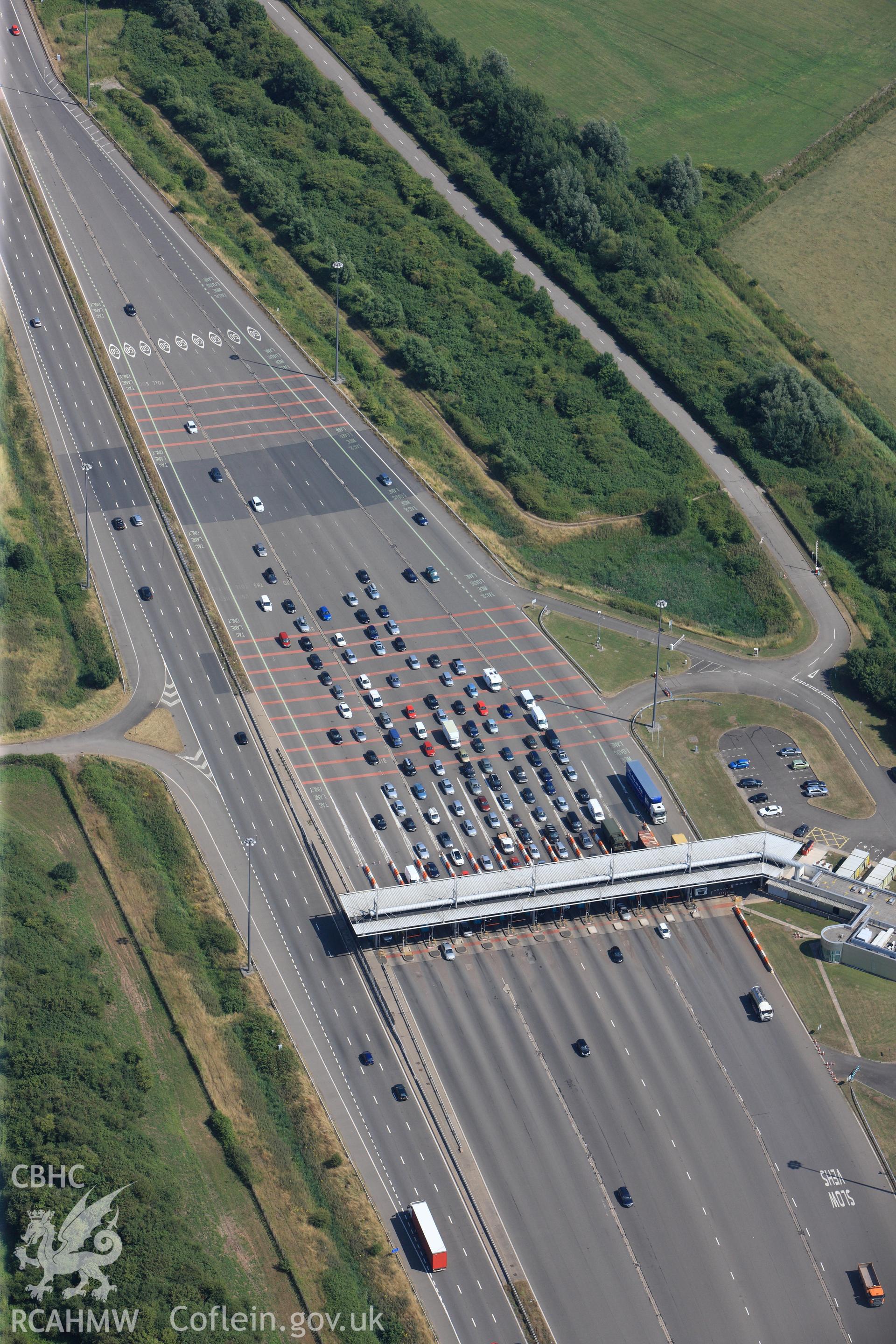Toll booth on the M4 motorway, just before passing southern edge of Caldicot on its way to the second Severn Crossing. Oblique aerial photograph taken during RCAHMW?s programme of archaeological aerial reconnaissance by Toby Driver, 01/08/2013.