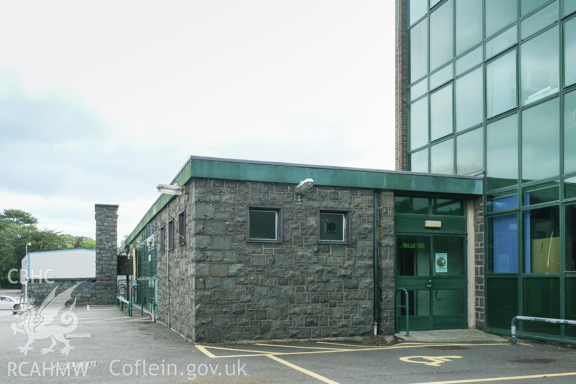 Digital colour photograph showing detailed exterior view of stone wall and entrance at Caernarfonshire Technical College, Bangor. Photographed by Dilys Morgan and donated by Wyn Thomas of Grwp Llandrillo-Menai Further Education College, 2019.