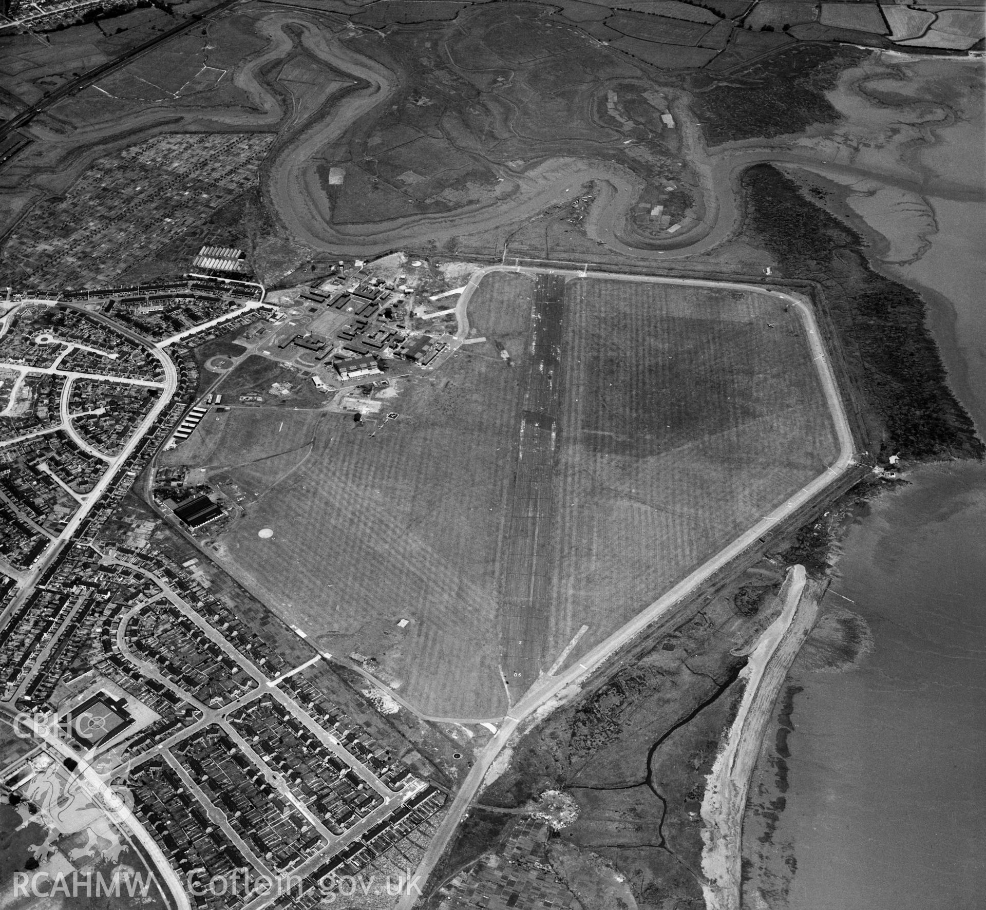 Digital copy of a black and white, oblique aerial photograph of Cardiff Aerodrome, Cardiff. The photograph shows a view from the South West. Note the extensive facilities constructed during its wartime incarnation as RAF Cardiff.
