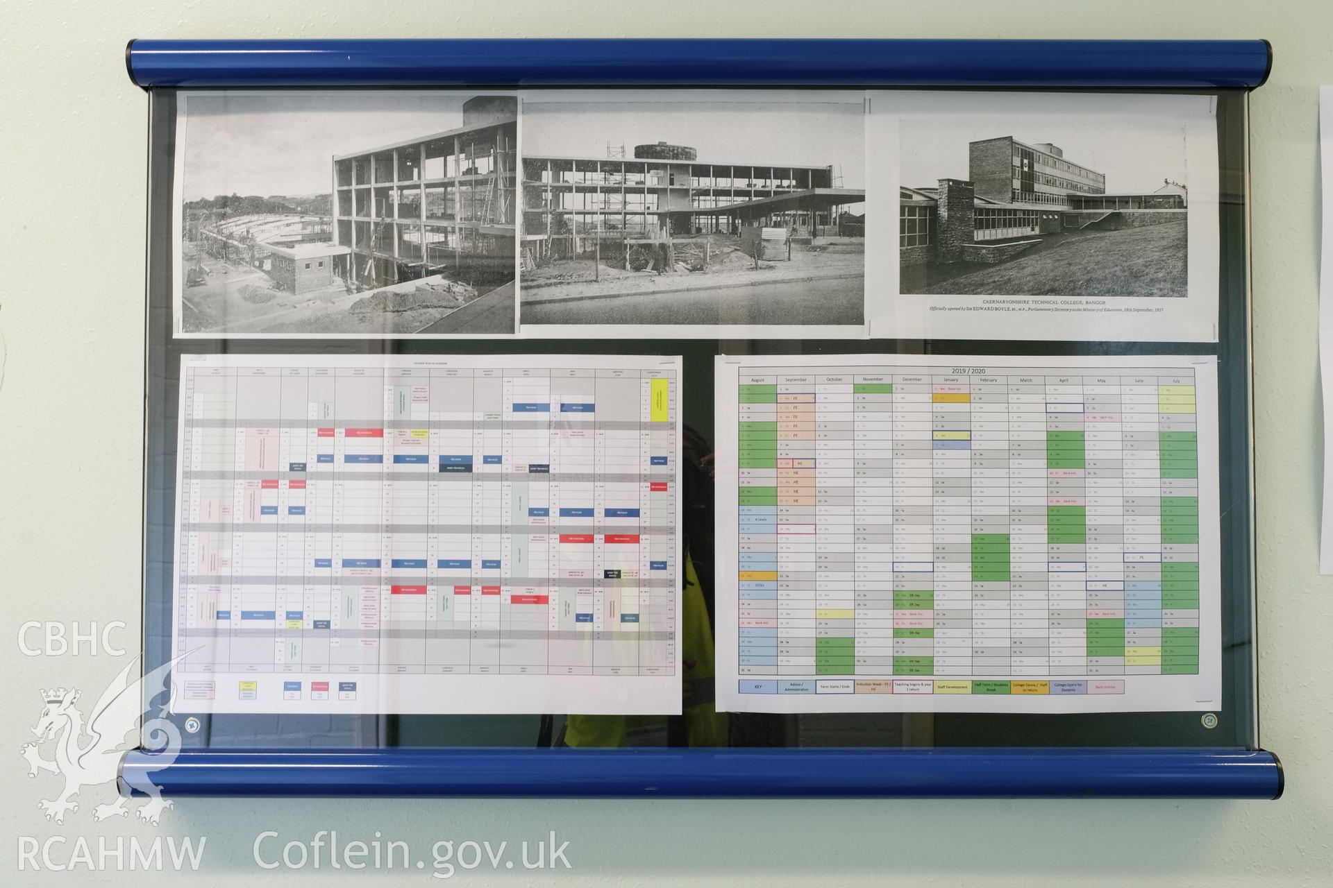 Digital colour photograph showing detailed view of black and white photographs of Caernarfonshire Technical College under construction. Photographed by Dilys Morgan and donated by Wyn Thomas of Grwp Llandrillo-Menai Further Education College, 2019.