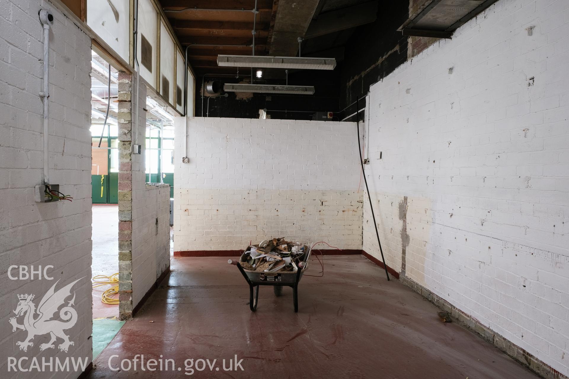 Digital colour photograph showing detailed interior view of room with wheelbarrow at Caernarfonshire Technical College, Ffriddoedd Road, Bangor. Photographed by Dilys Morgan, donated by Wyn Thomas of Grwp Llandrillo-Menai Further Education College, 2019.