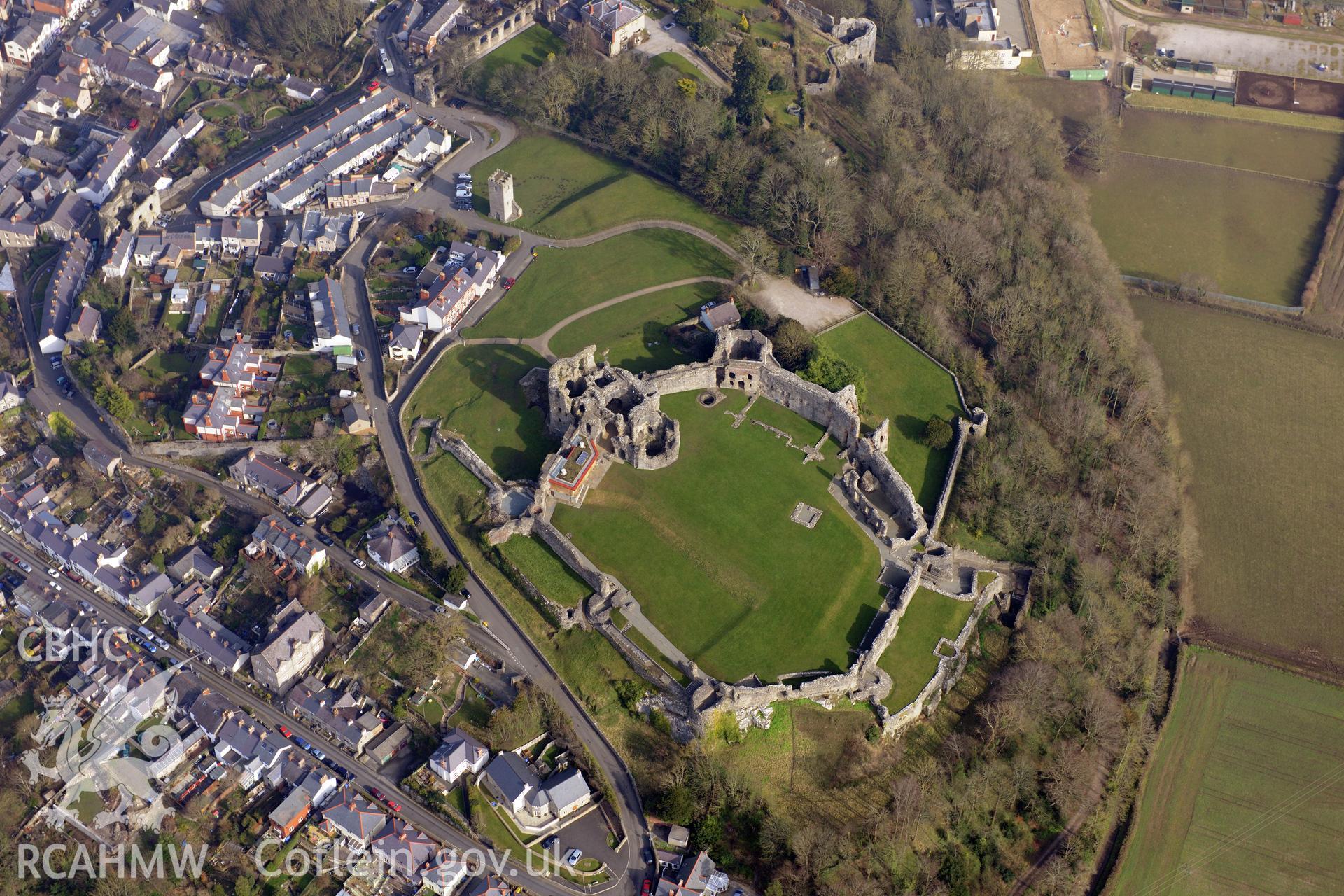 Denbigh Castle, the Cadw visitor's centre at the castle and the surviving tower of St. Hilary's chapel, Denbigh. Oblique aerial photograph taken during the Royal Commission?s programme of archaeological aerial reconnaissance by Toby Driver on 28th February 2013.