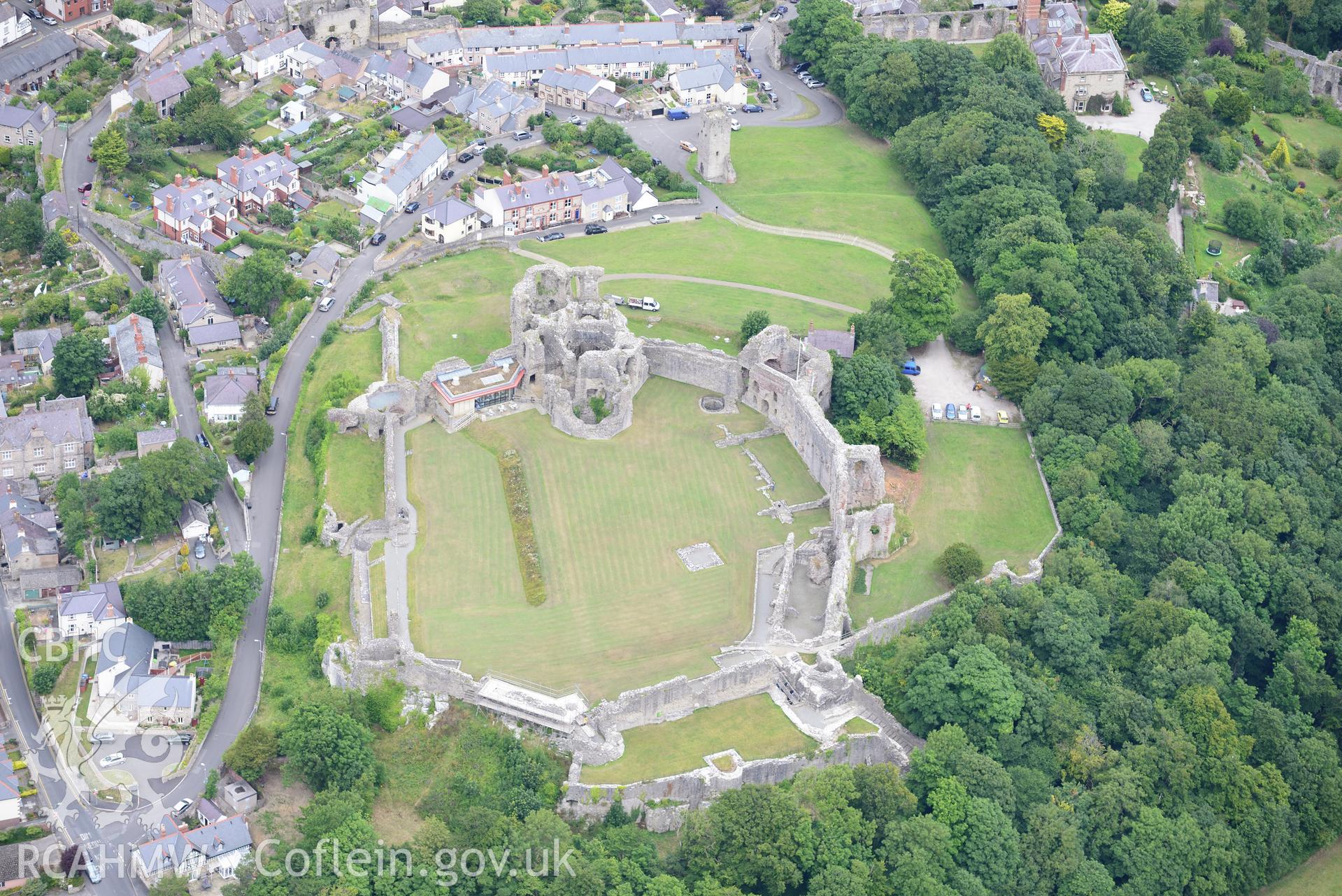 Denbigh Castle and Cottage, St Hilary's Chapel, town walls, visitor centre, Gwalia Villas and Coed Cwningaer. Oblique aerial photograph taken during the Royal Commission?s programme of archaeological aerial reconnaissance by Toby Driver on 30th July 2015.