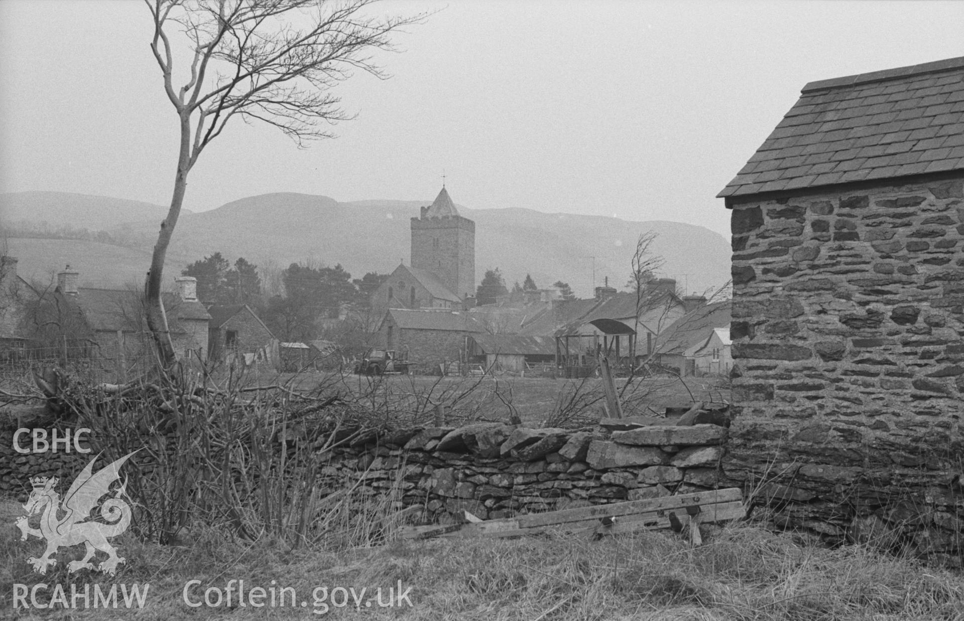 Digital copy of a black and white negative showing a prominent St David's Church in the village of Llanddewi Brefi. Photographed in April 1963 by Arthur O. Chater, from Grid Reference SN 6617 5532, looking east.