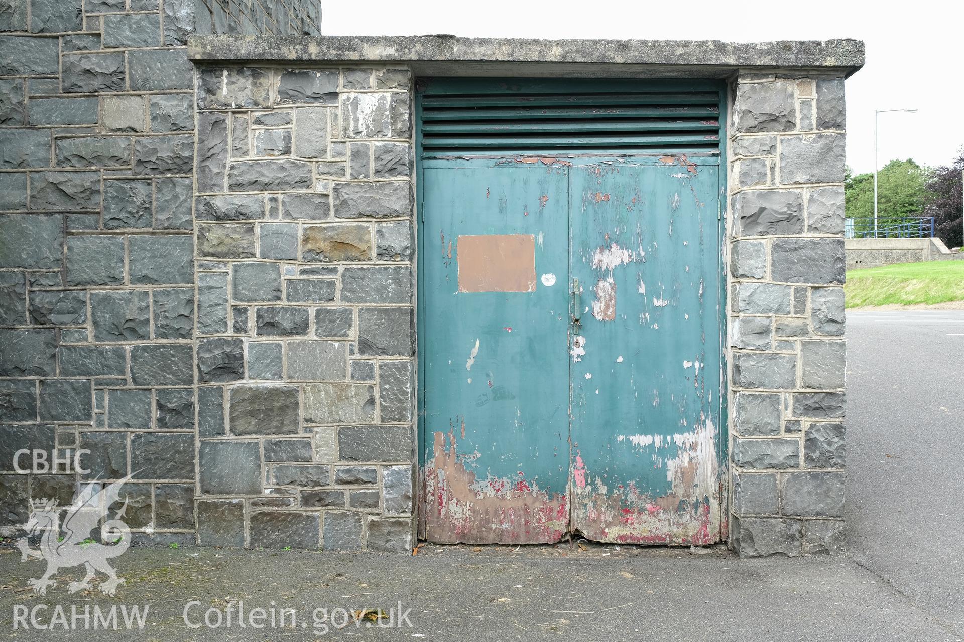 Digital colour photograph showing detailed exterior view of door and stone wall at Caernarfonshire Technical College, Ffriddoedd Road, Bangor. Photographed by Dilys Morgan and donated by Wyn Thomas of Grwp Llandrillo-Menai Further Education College, 2019.