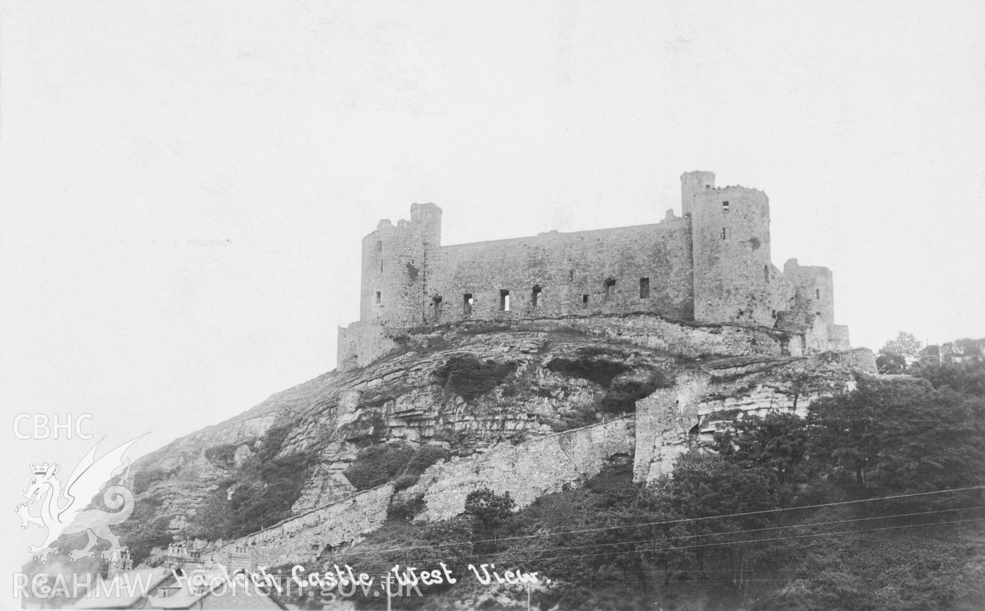 Digital copy of a black and white postcard relating to Harlech Castle: general view from west.