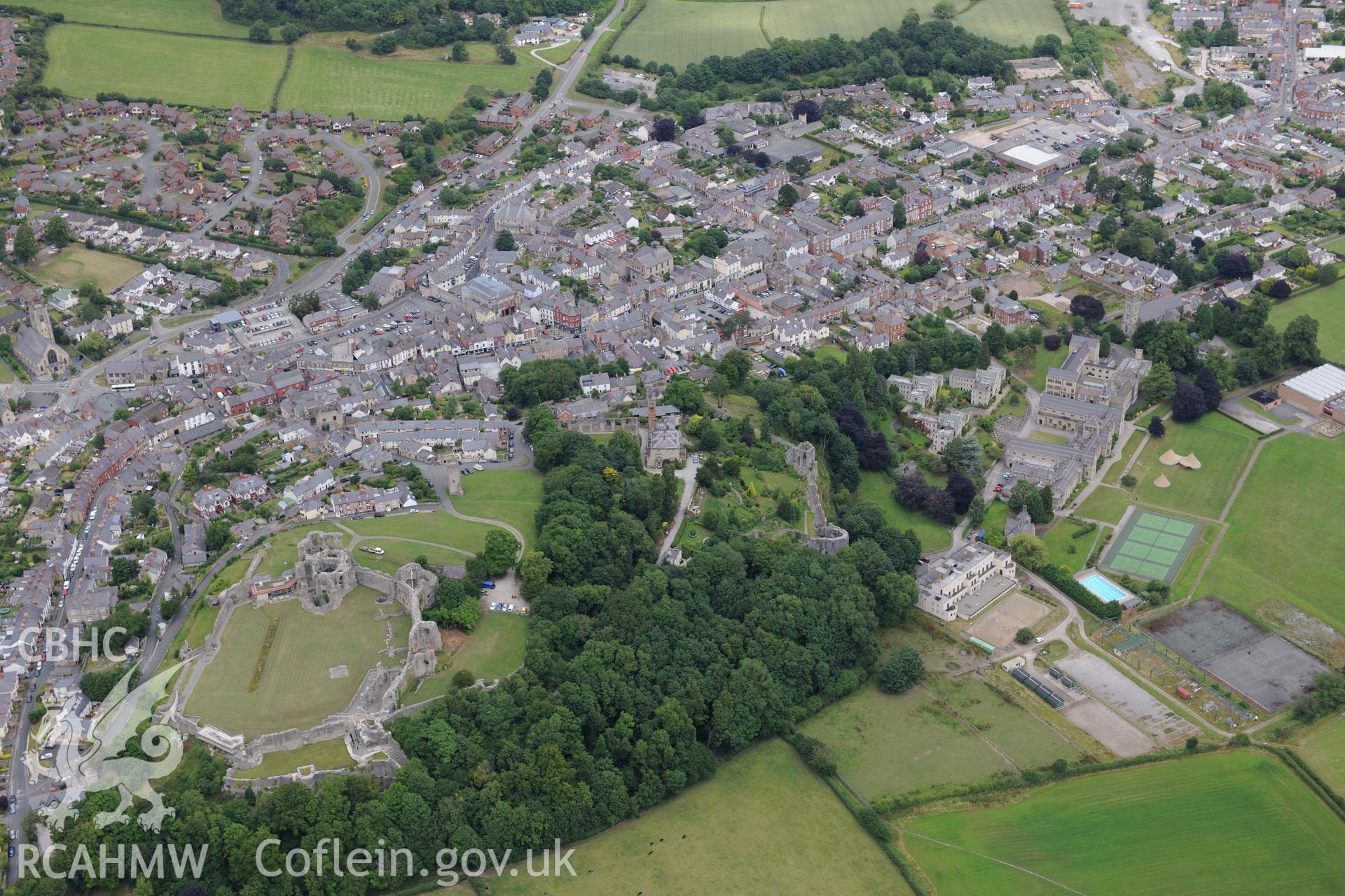 Denbigh Castle, Castle House, town walls, Goblin Tower, St. Mary's Church, Howell's School and Coed Cwningaer. Oblique aerial photograph taken during the Royal Commission's programme of archaeological aerial reconnaissance by Toby Driver on 30th July 2015.
