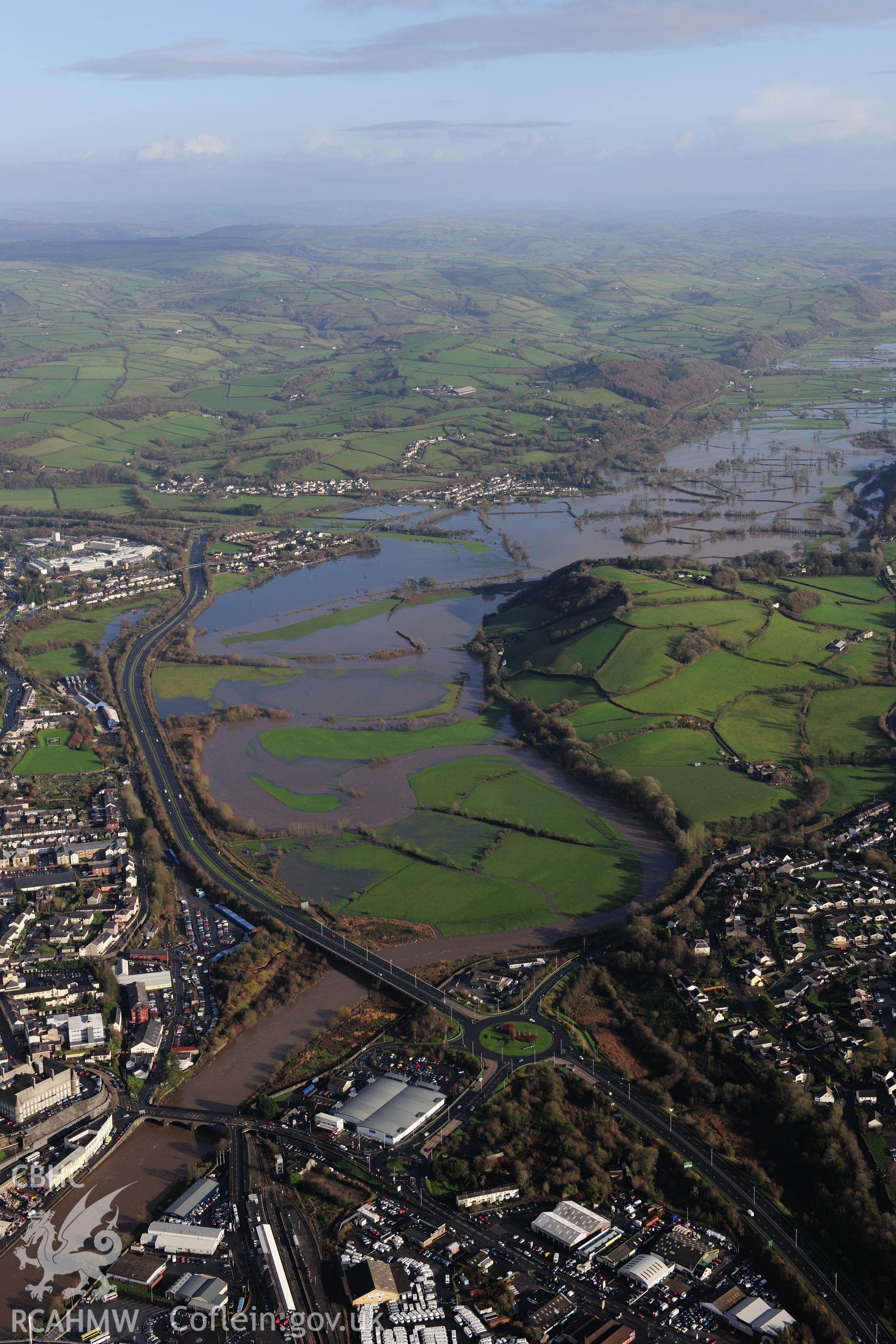 RCAHMW colour oblique photograph of Carmarthen townscape, looking east with flooding on the Tywi. Taken by Toby Driver on 23/11/2012.