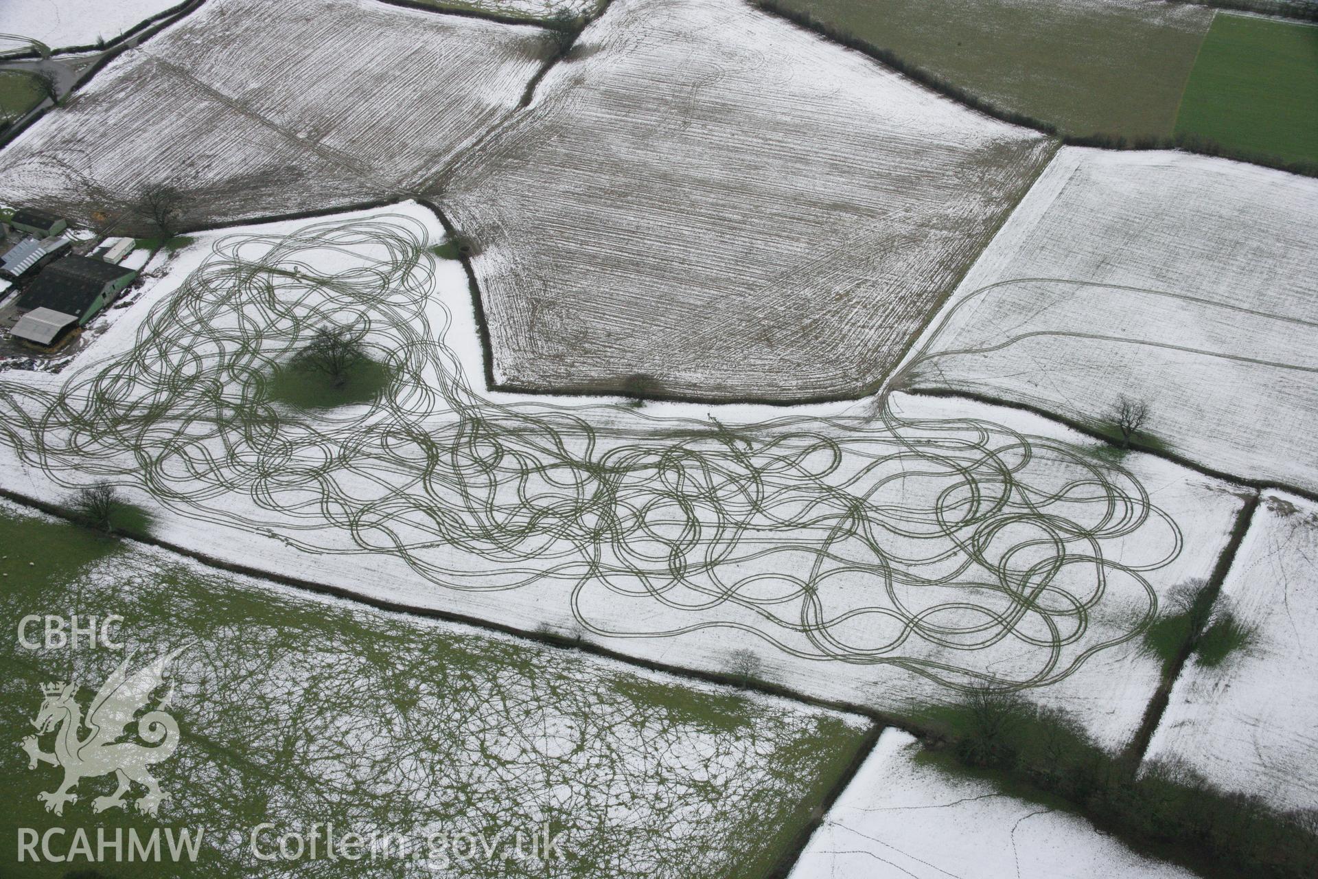 RCAHMW colour oblique aerial photograph of Tyddyn Isaf showing patterns in the snow to the north-west of the farm. Viewed from the north-east. Taken on 06 March 2006 by Toby Driver.