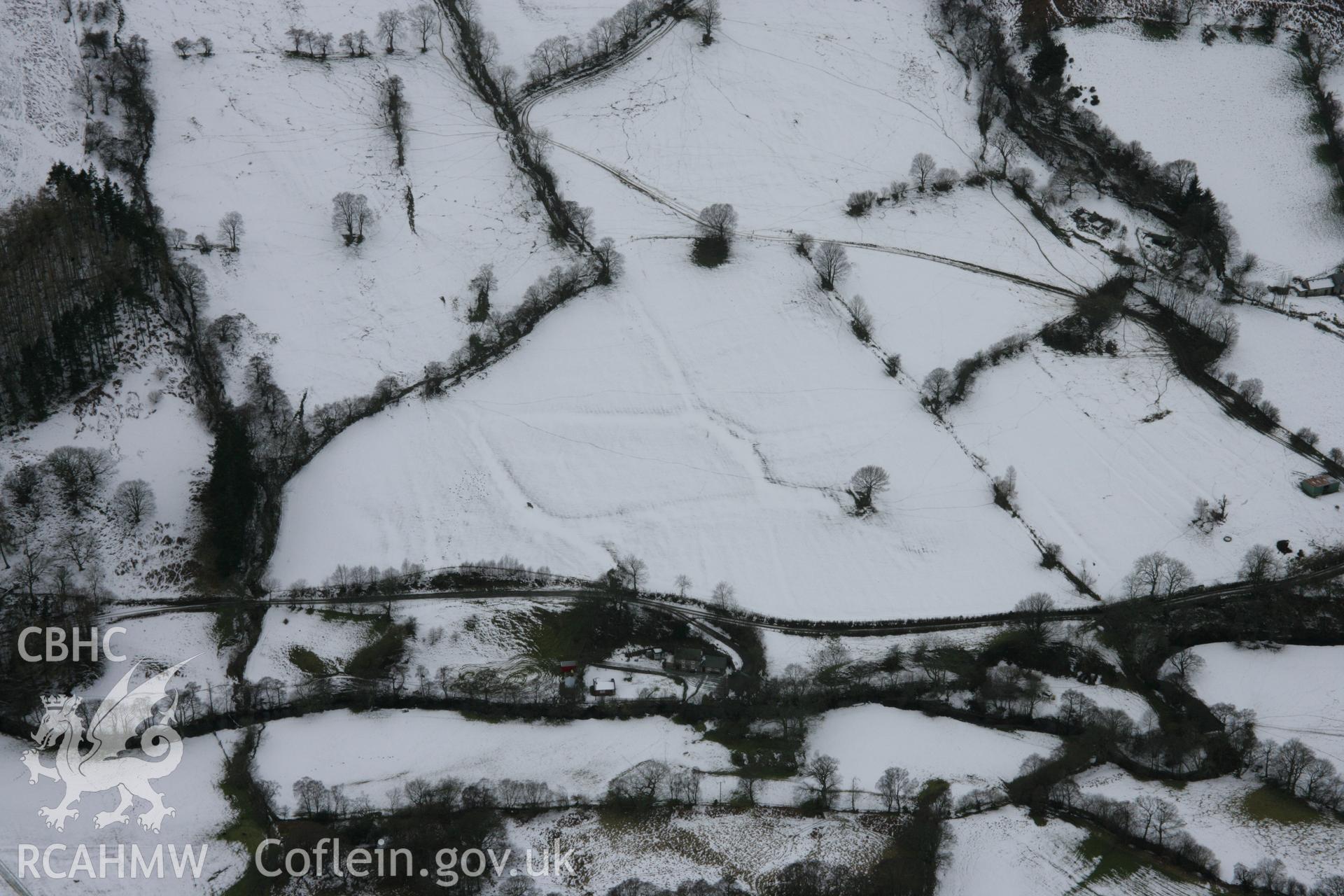 RCAHMW colour oblique aerial photograph of Nant Buarth-Glas Field System, viewed from the north-east under snow. Taken on 06 March 2006 by Toby Driver.