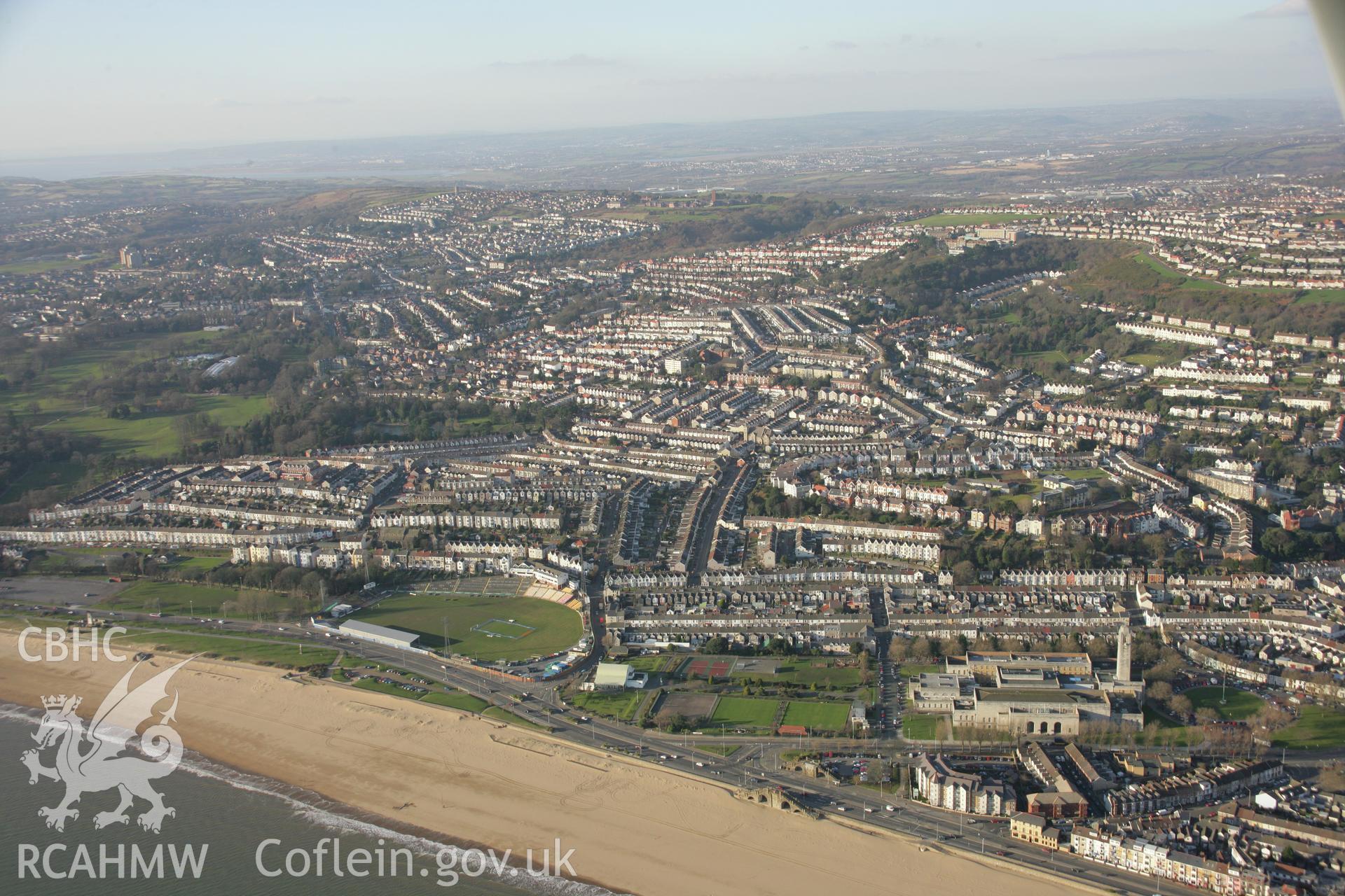 RCAHMW colour oblique aerial photograph of Guildhall, Swansea from the south-east. A wide view with the Uplands area beyond. Taken on 26 January 2006 by Toby Driver.