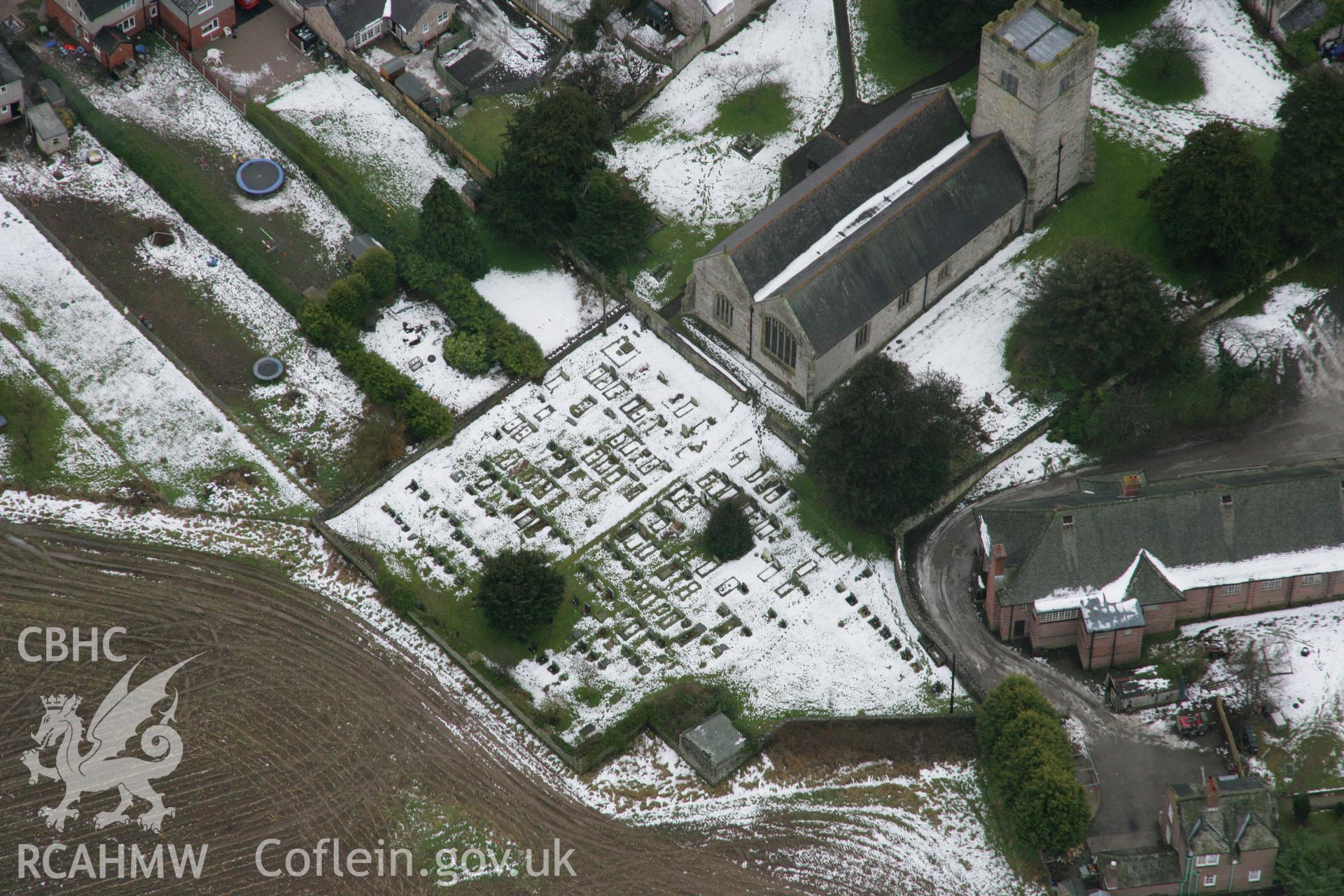 RCAHMW colour oblique aerial photograph of St Cynfarch and St Mary's Church, Llanfair Dyffryn Clwyd, showing the graveyard under snow. Taken on 06 March 2006 by Toby Driver.
