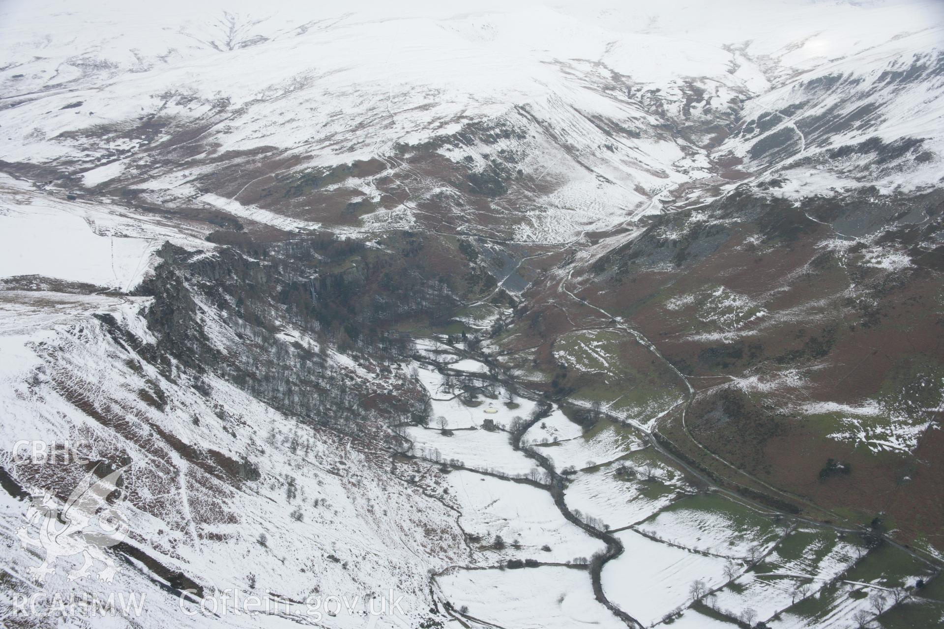 RCAHMW colour oblique aerial photograph of Cwm Blowty and Pistyll Rhaeadr Waterfall and Walks, under snow in a landscape view from the south-east. Taken on 06 March 2006 by Toby Driver.